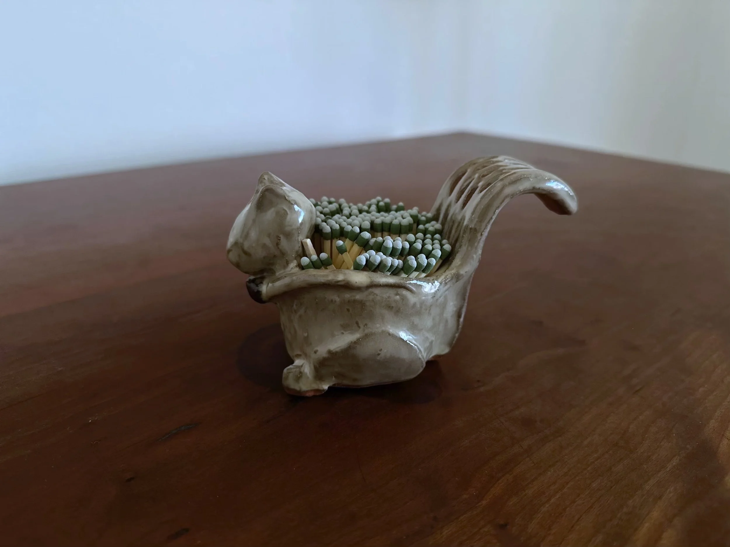 squirrel holding matches by Yellowstoneware by jesse Fales copy.jpg
