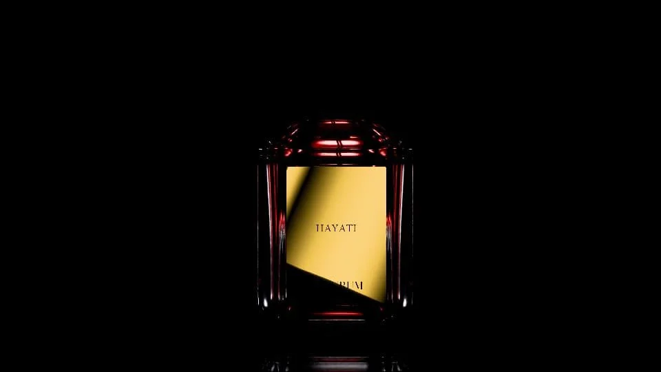 A dark background with a glass container holding a yellow card with the word 'HAYATI' on it.
