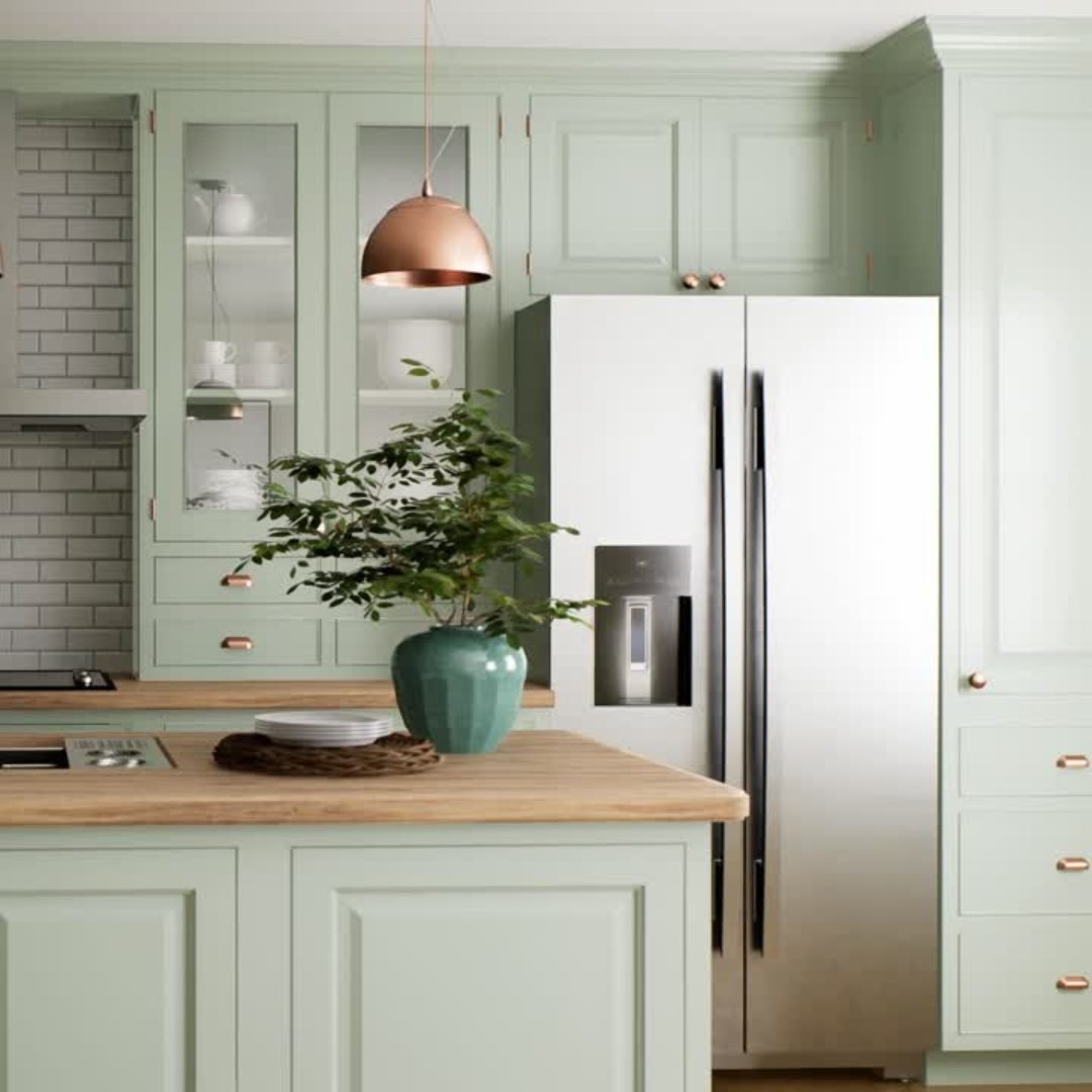 Modern kitchen with mint green cabinets and a wood countertop