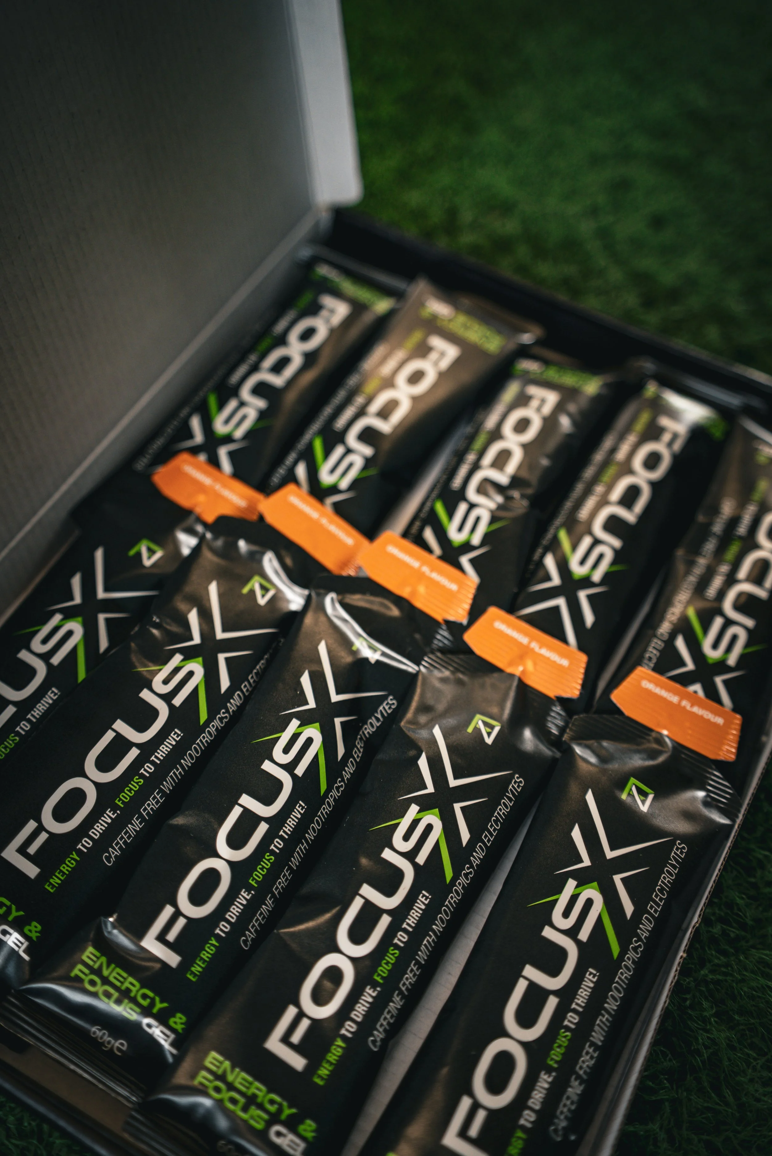 An open box containing multiple Focus energy gels, with some orange-scooped ones on top.