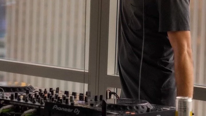 DJ equipment and person standing by window
