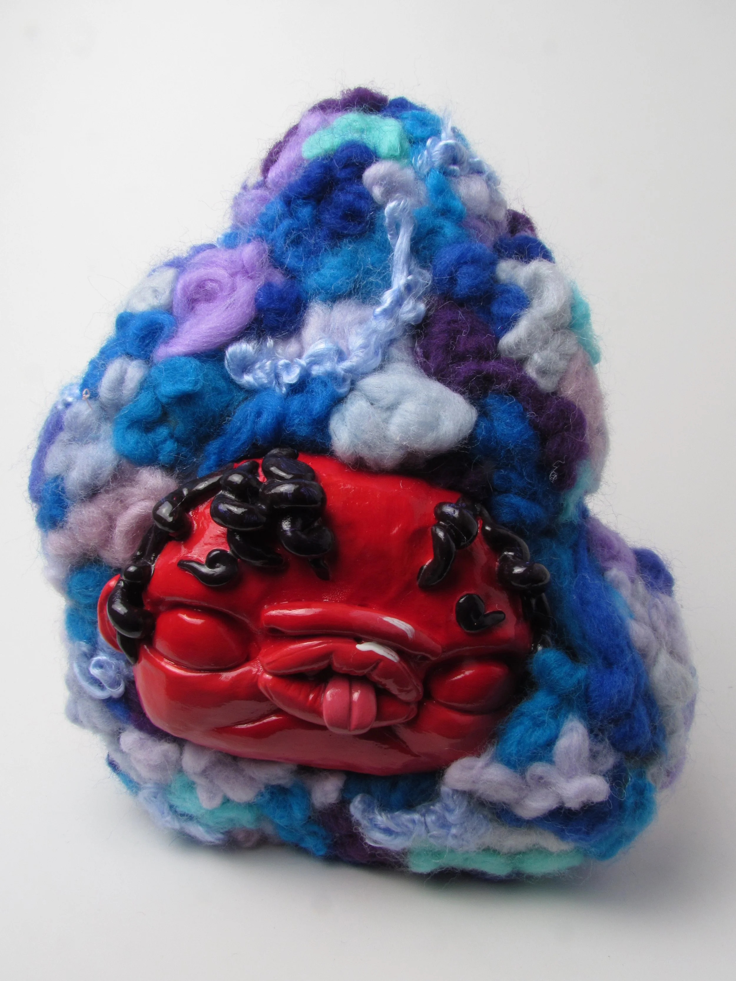 Red creature in blue (back).

Polymer clay, dyed wool, wire, beads, acrylic paint 
19 x 18 x 12 cm
2024