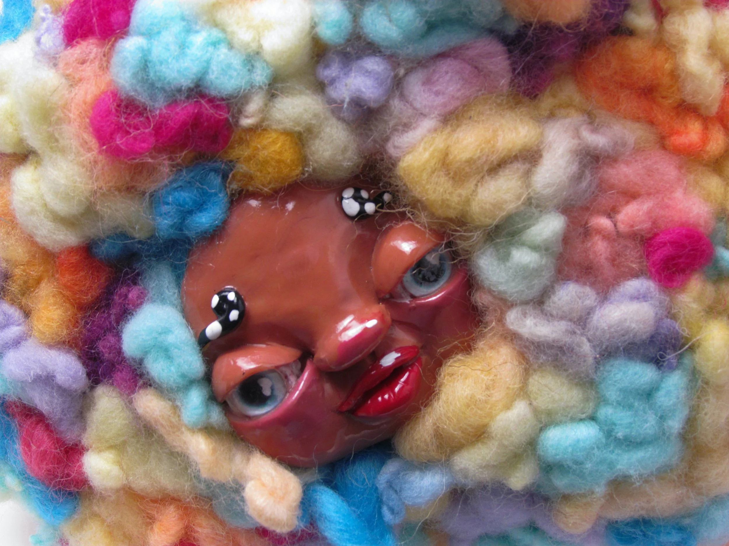 Yellow creature with spots.

Polymer clay, dyed wool, wire, beads, acrylic paint 
18 x 19 x 11 cm
2024