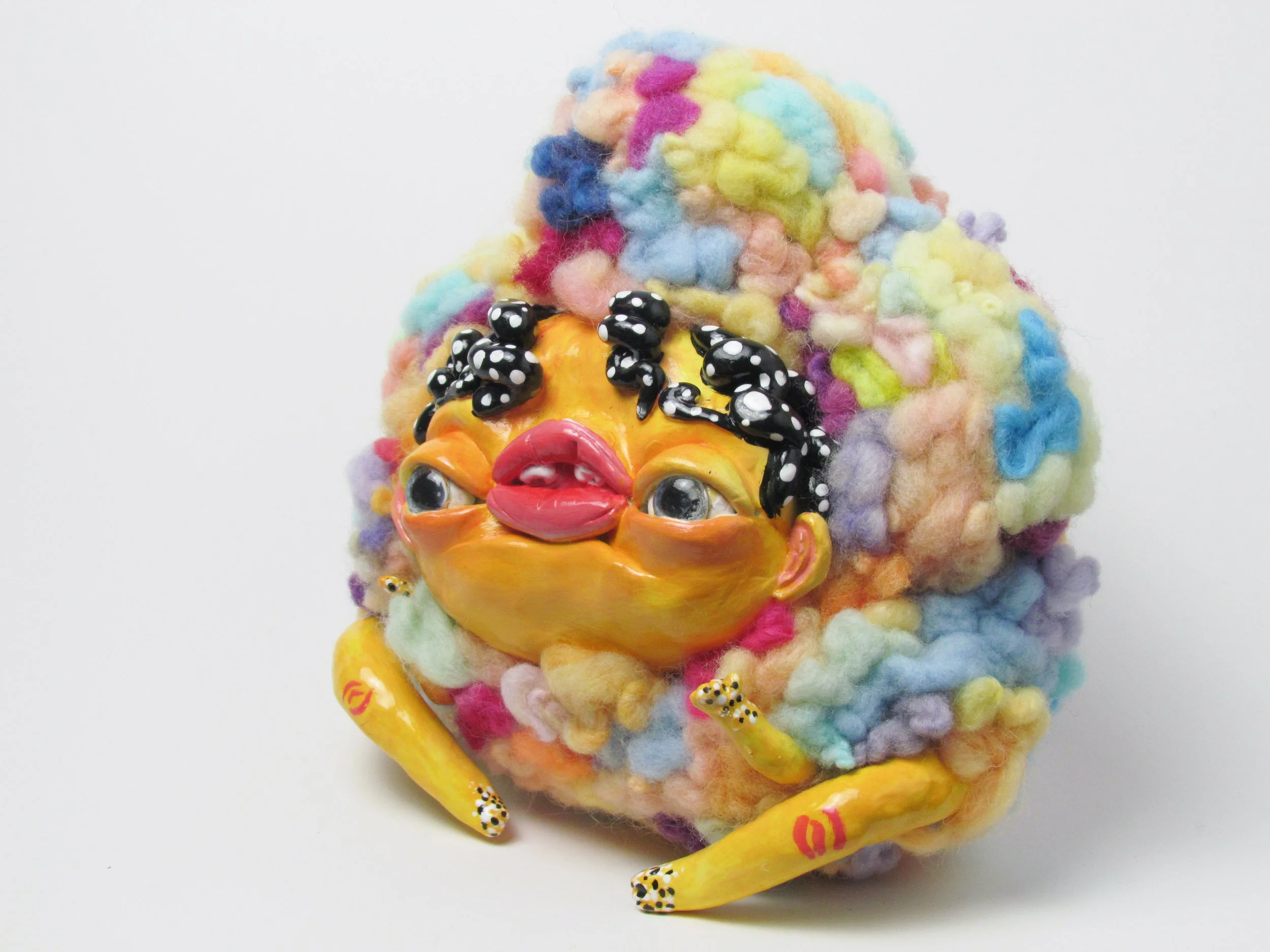 Yellow creature with spots.

Polymer clay, dyed wool, wire, beads, acrylic paint 
18 x 19 x 11 cm
2024