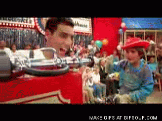 A kid in a cowboy hat screams excitedly before a fire-hose is turned on in their face and they fly offscreen