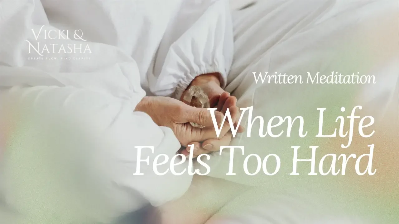 Vicki dressed in white, seated with a crystal held between her hands, with the words “Written Meditation: When Life Feels Too Hard.”
