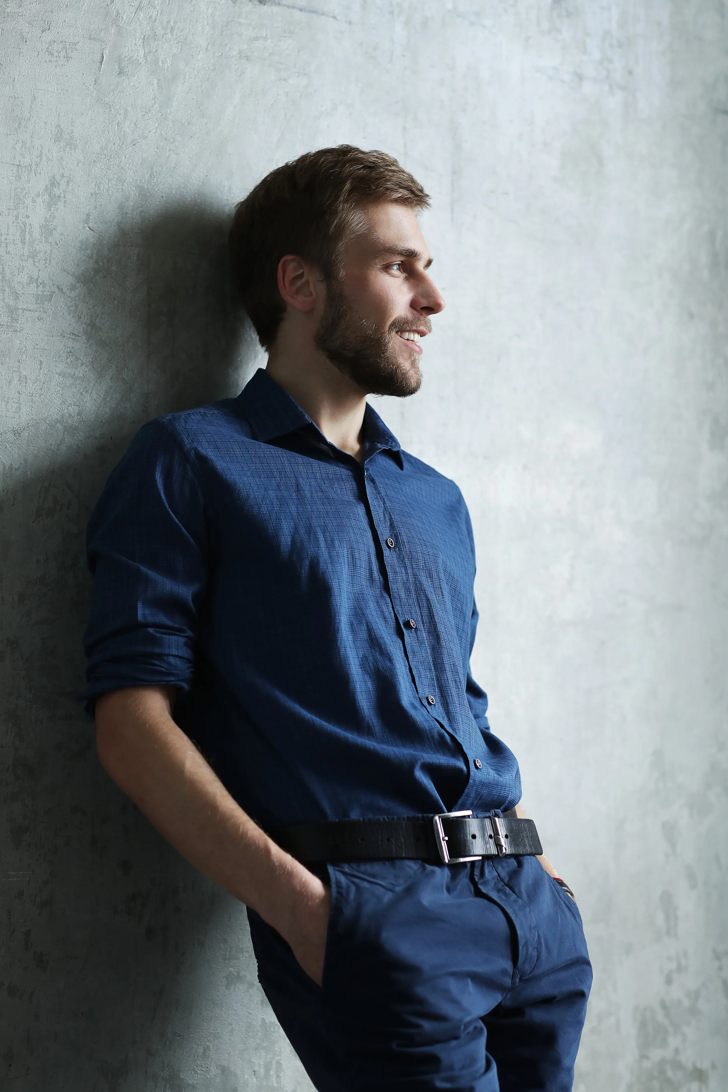 Image of a professional adult male leaning against a wall considering reaching out to LifewRx Mental Health and Wellness, located in Columbus and Middleburg Heights, Ohio