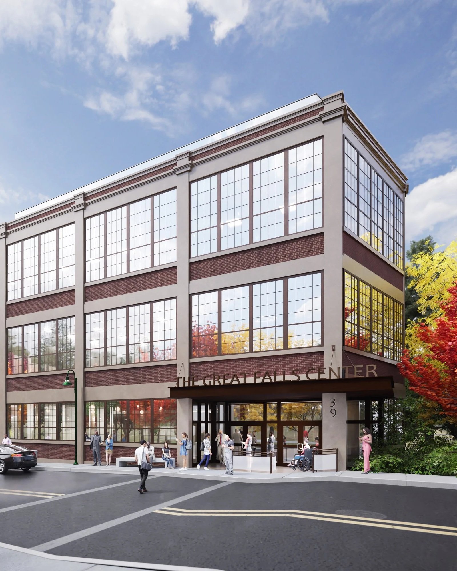 Rendering of The Great Falls Center, a multi-story brick building with large windows, with people waiting at the entrance, surrounded by fall-colored trees.