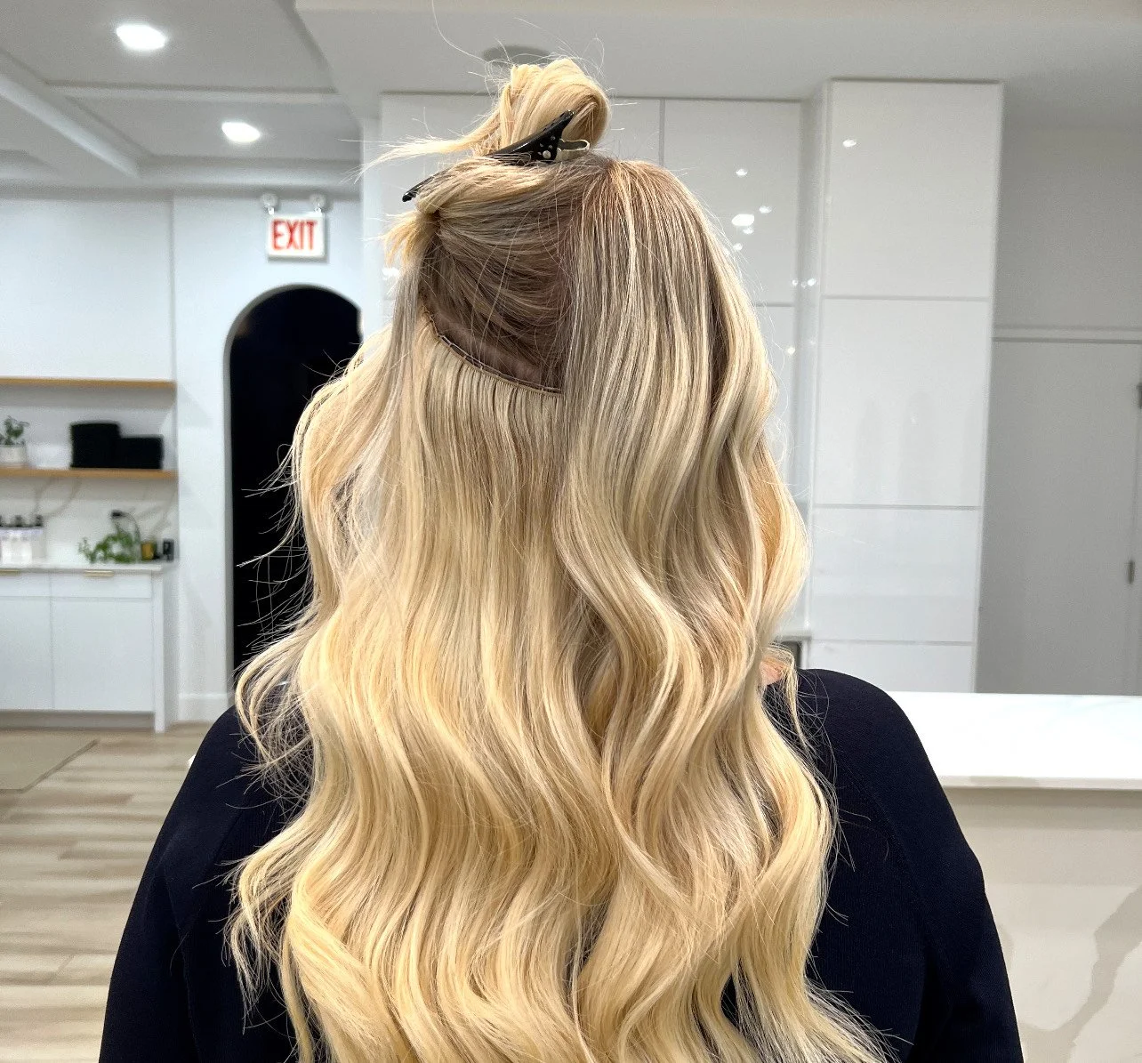 Blonde hair with clip-in extensions in a salon setting