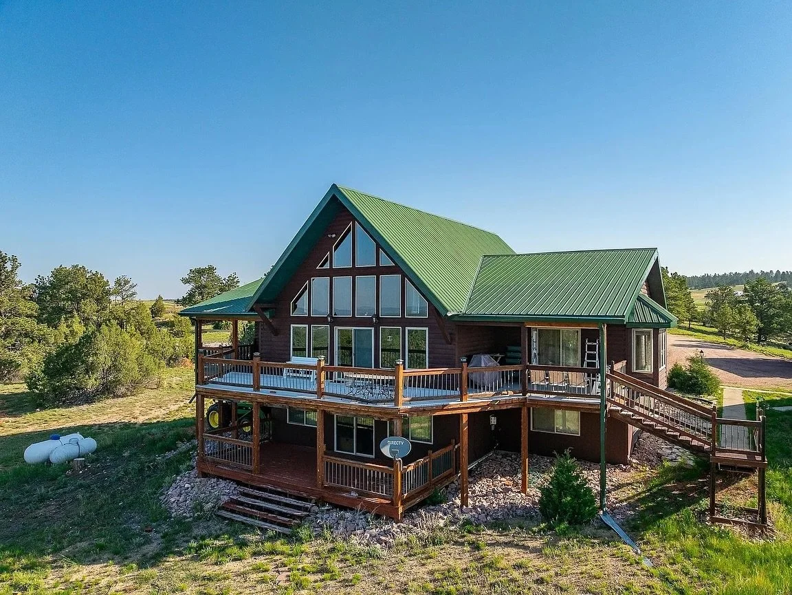 See more link 🔗 in bio!
40 acres in the Black Hills + a guest cabin + direct access to 80 acres of National Forest. 🌲

This Custer retreat features soaring vaulted ceilings, wrap-around deck views, and space for everyone&mdash;listed at $959,000.

