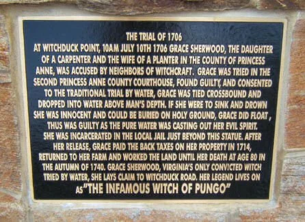 Plaque on the statue "restoring the name" of the alleged Witch of Pungo