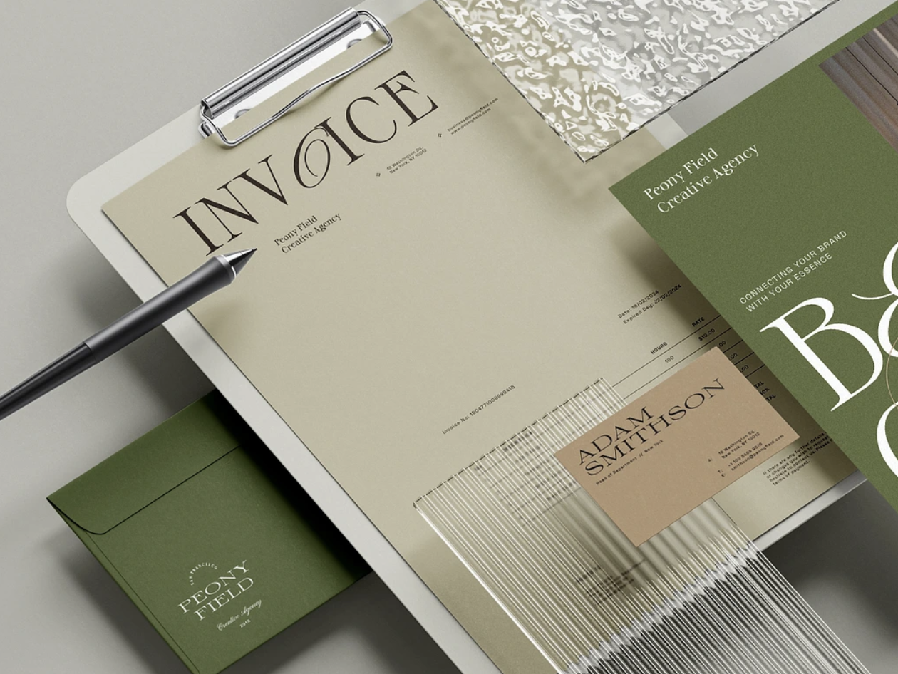 Colorful notebooks with gold embossed text reading 'NOTES' on their covers, arranged on a multicolored surface with pink paper fan on the side.