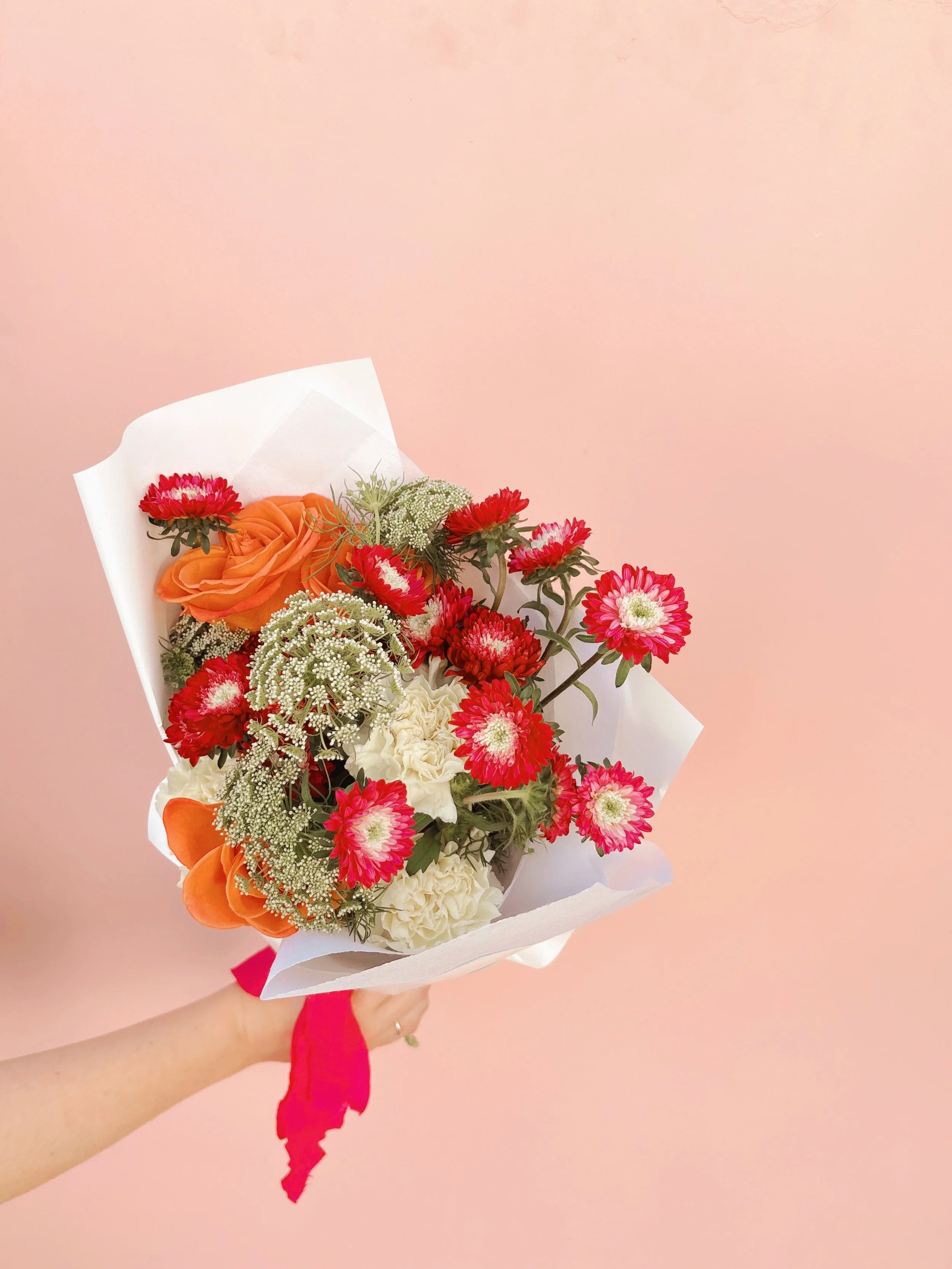 Colourful bouquet by Brisbane florist From June featuring roses, dahlias and seasonal blooms.