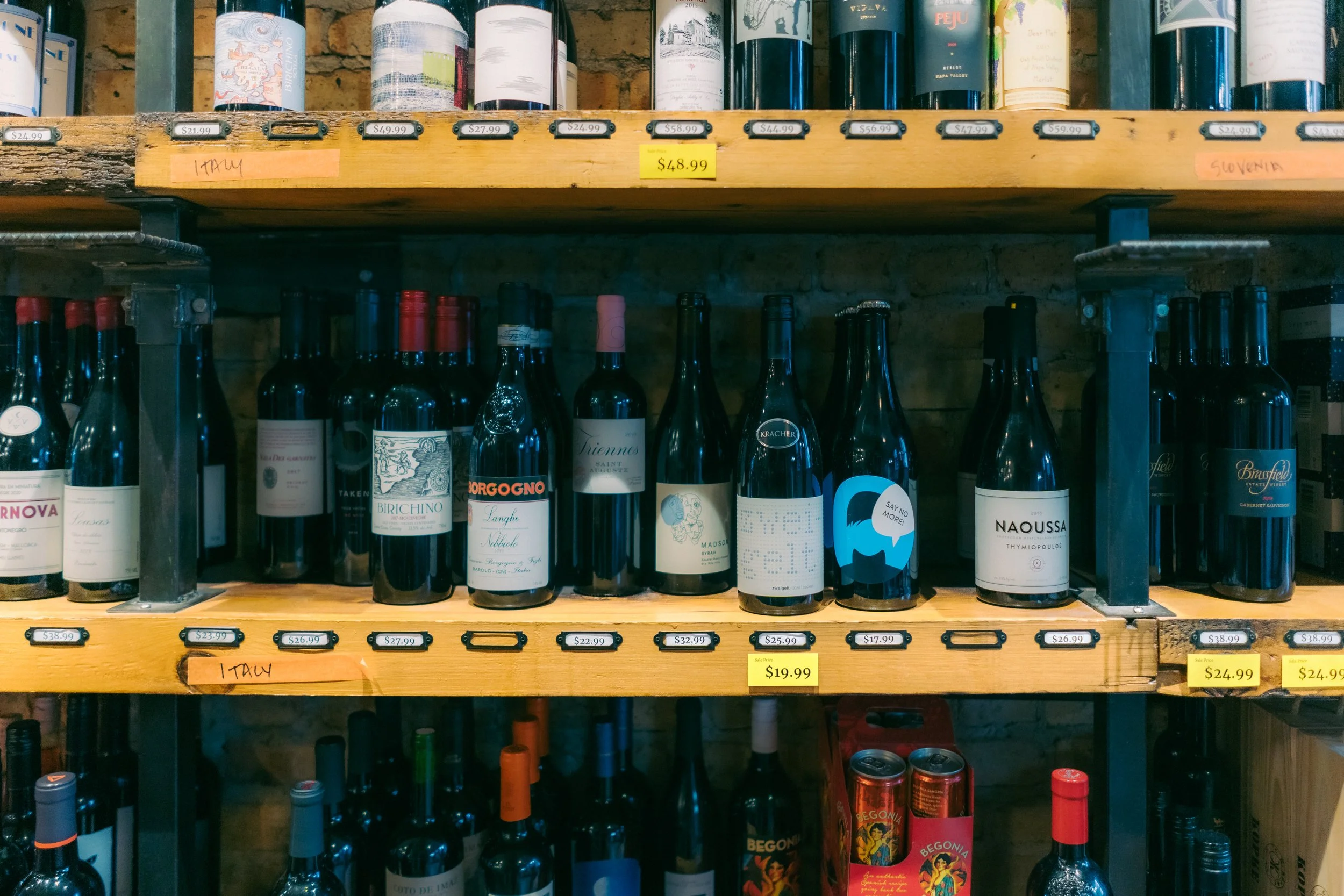 Shelves of various bottles of wine with price tags at The Buzz