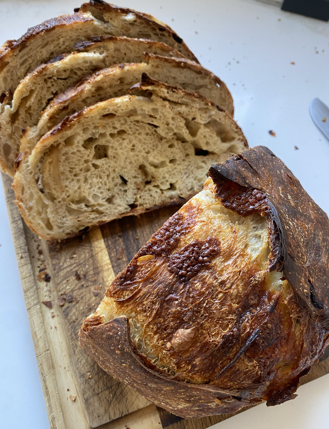 Caramelized Onion and Gruyere Sourdough Baked Loaf Sliced on Board Rebecca Witt Sourdough Mama