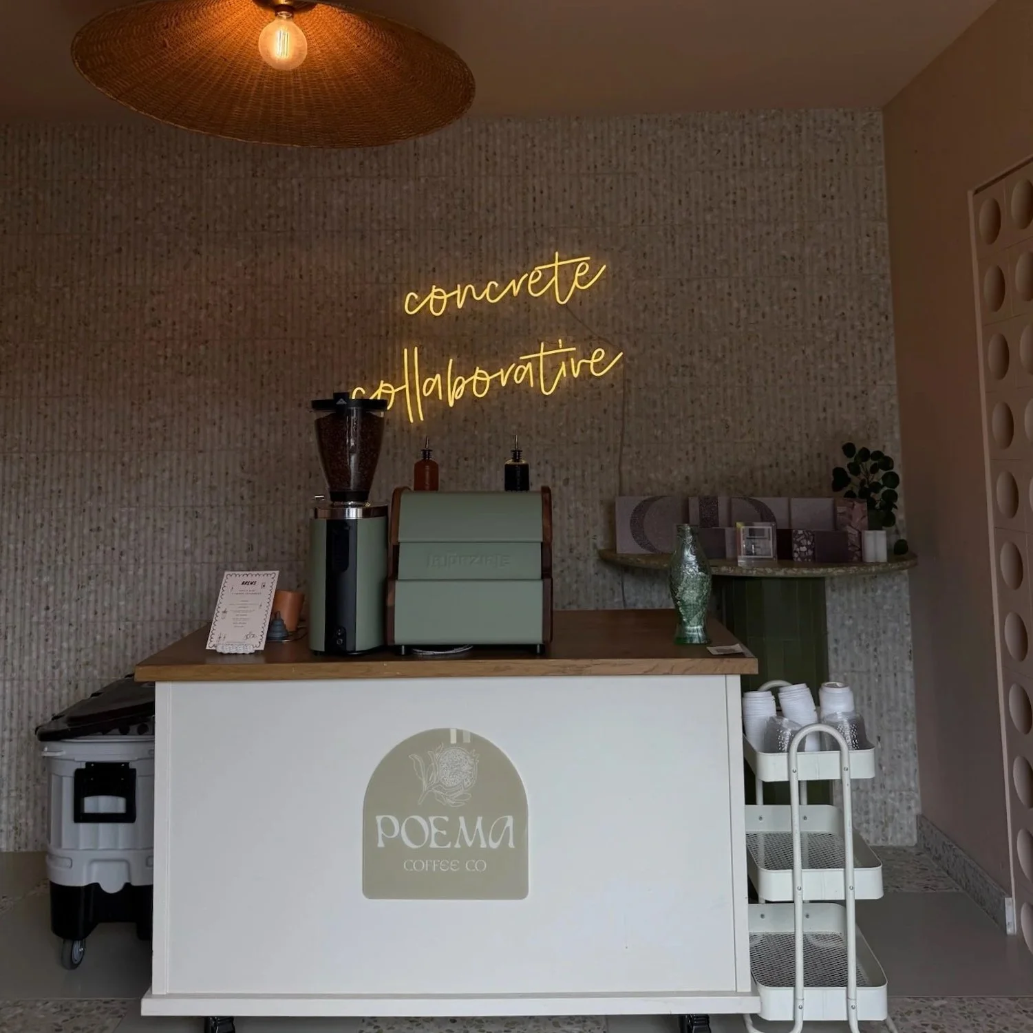 Poema mobile coffee cart set up at a corporate event space with a neon 'Concrete Collaborative' sign