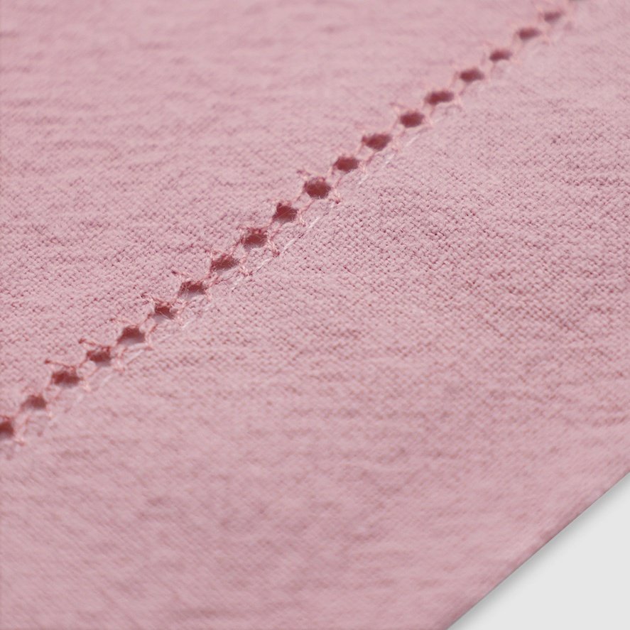 The hemstitch detail of Pam Pan's pink cotton napkin