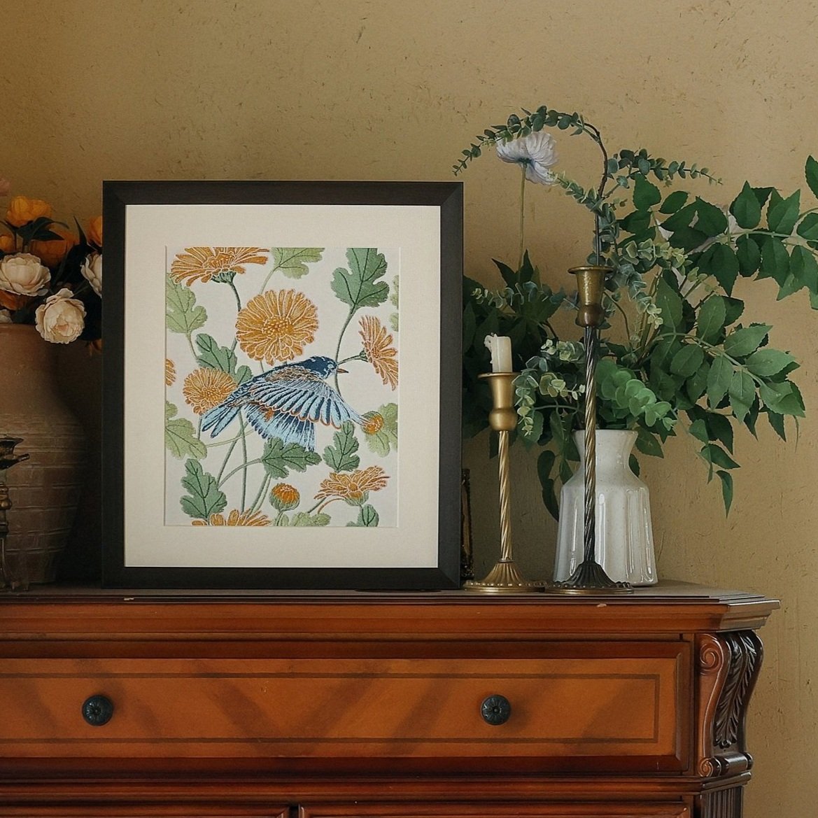 Garden series embroidery art of bird and calendula placed on a counter with floral decors