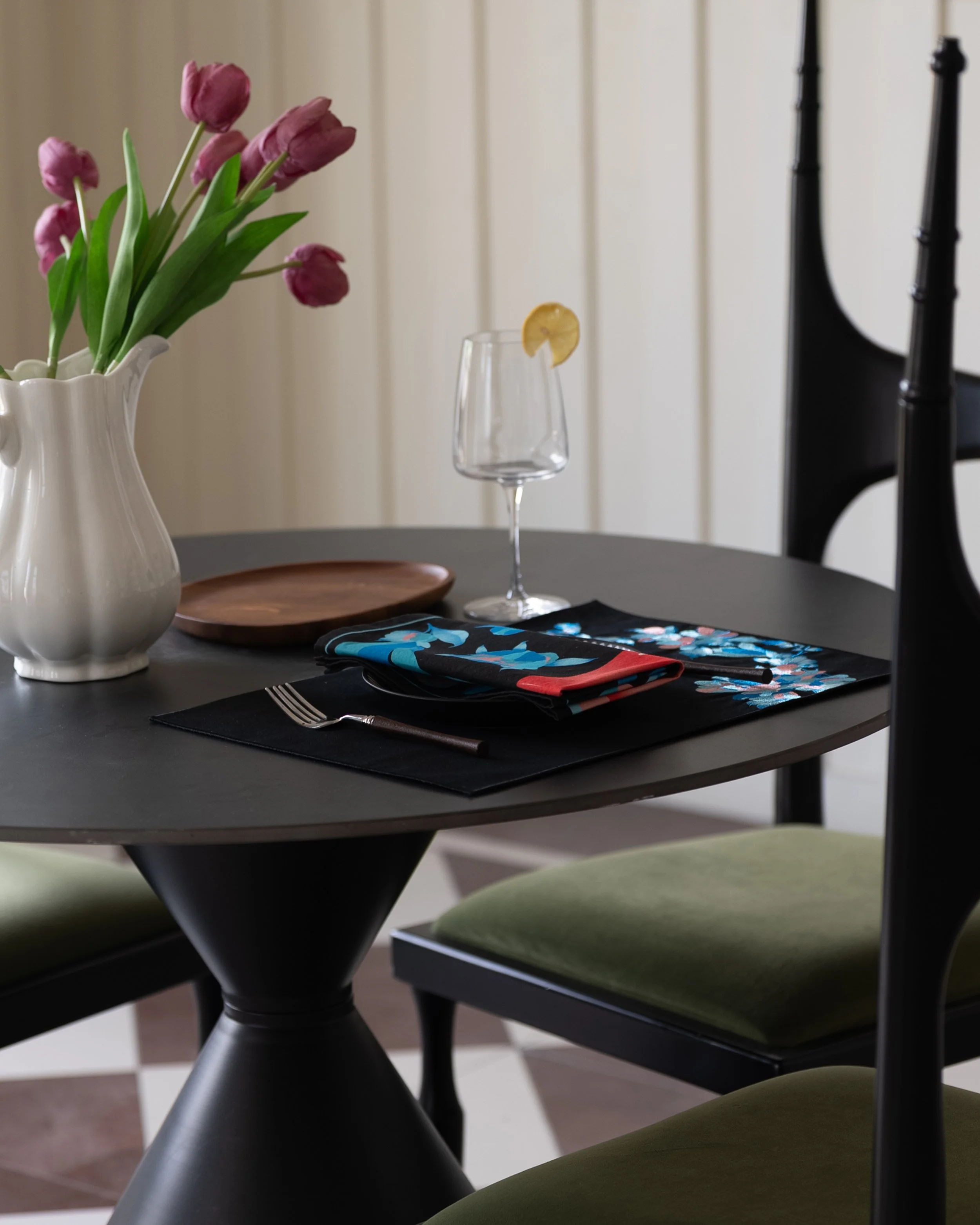 Etherelle placemat and napkin placed on a black round table.jpg