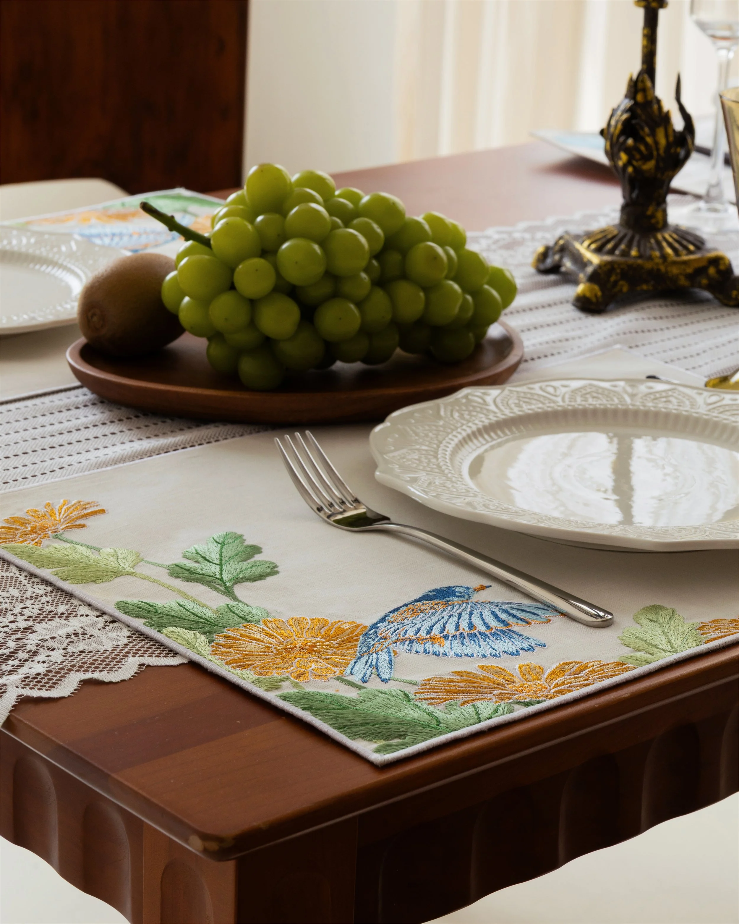 Garden embroidered ramie cotton napkin on a wooden dining table.jpg