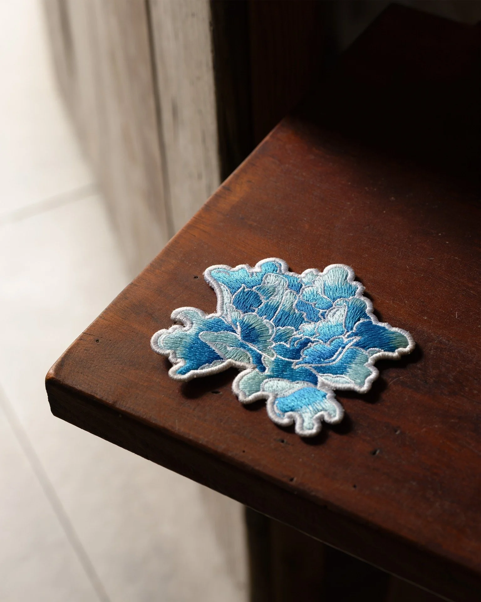 The Etherelle coaster is one of those small things you don&rsquo;t really plan for, but once it&rsquo;s there, it just makes the whole table feel more complete.

The blue embroidery catches the light a little, so even something as simple as a cup of 