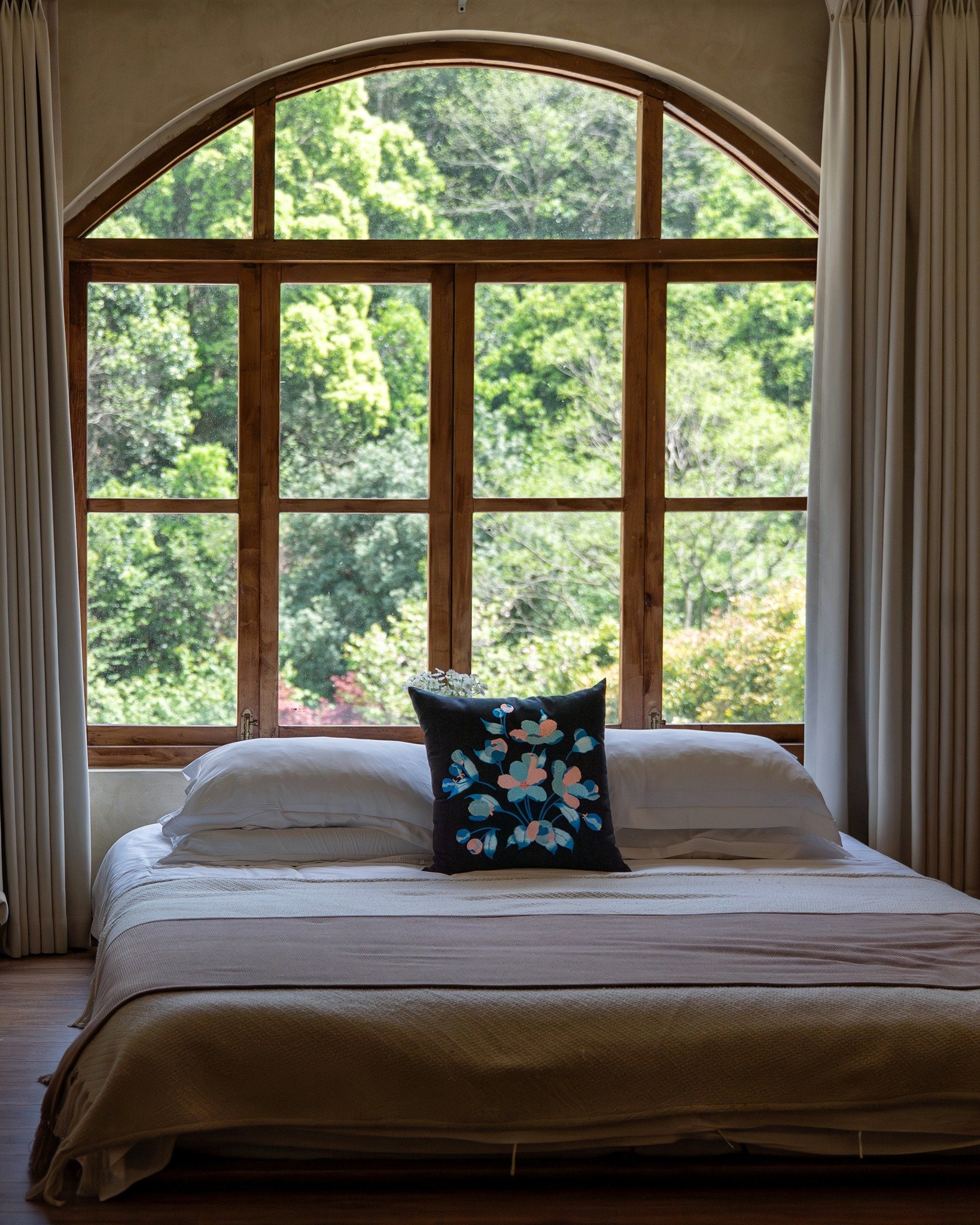 On a bed, the embroidered throw pillow from Etherelle series gives just enough contrast against all the light tones. On a chair by the window, it picks up the greens outside and feels a bit more alive.

#embroideredpillows #throwpillows #decorativepi