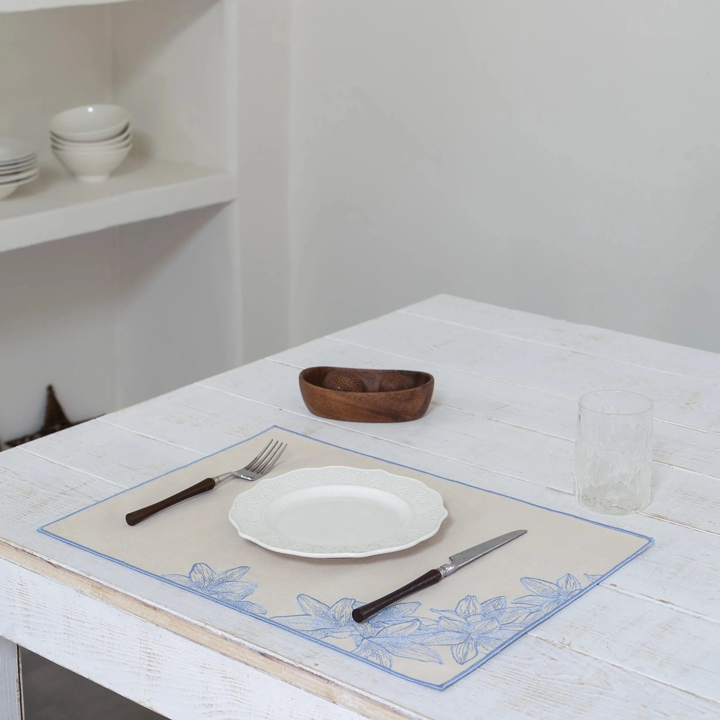 Lily+embroidered+placemat+on+a+white+wooden+table.jpg