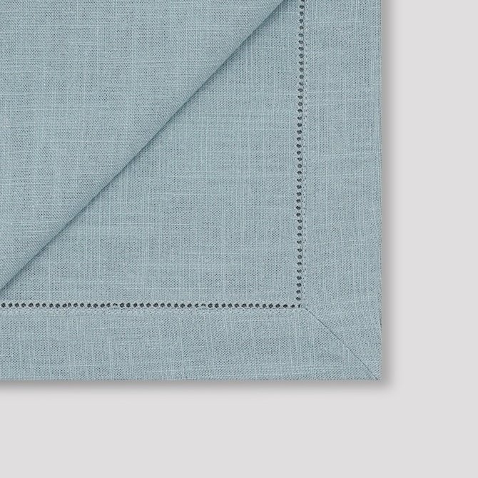The mitered corner details of the teal hemstitched ramie blend napkin