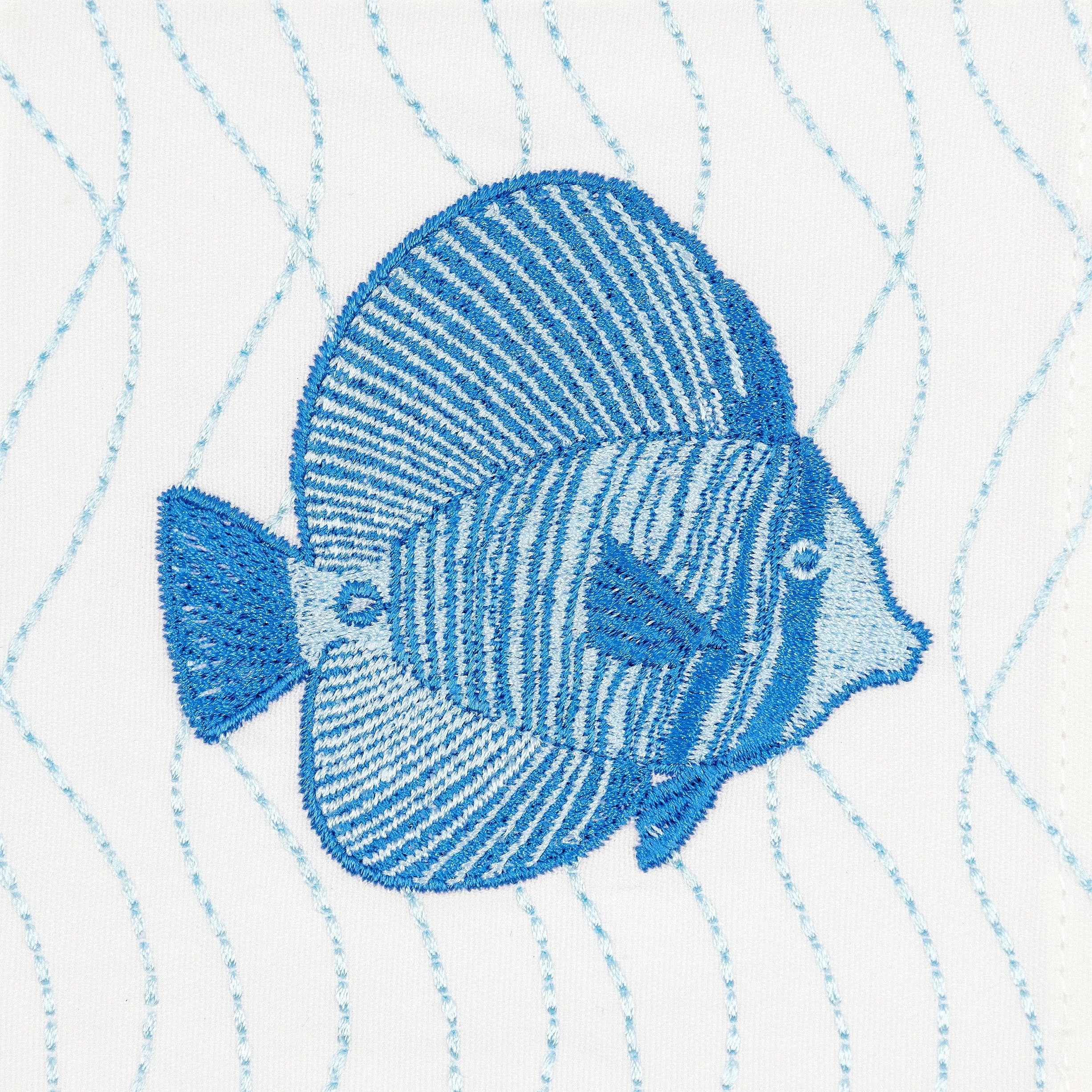 Close-up of the blue fish embroidery on the Aqua cocktail napkin — fine thread detailing and wave-line stitching on white cotton.