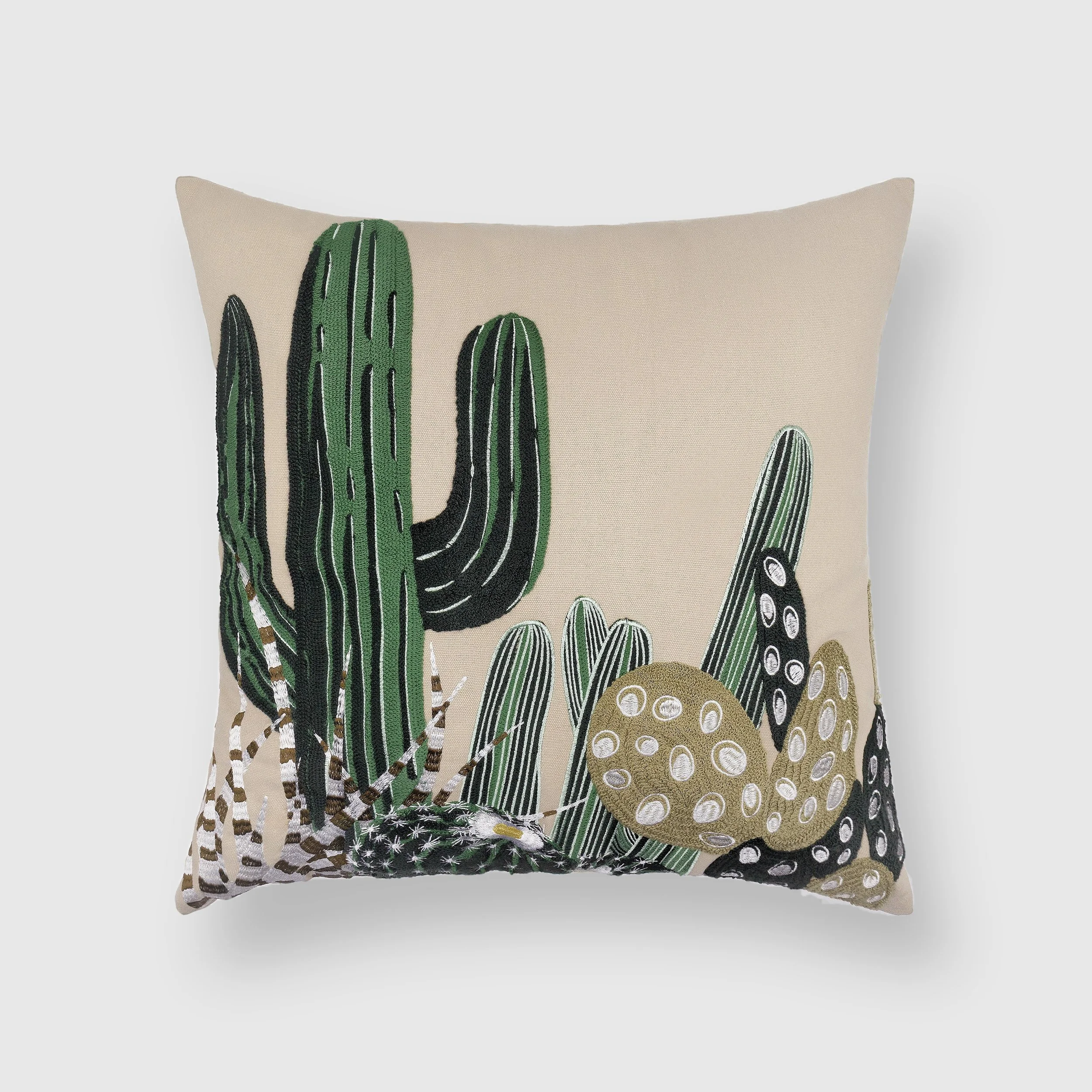 Arid embroidered throw pillow featuring cacti and desert plants on natural cotton fabric