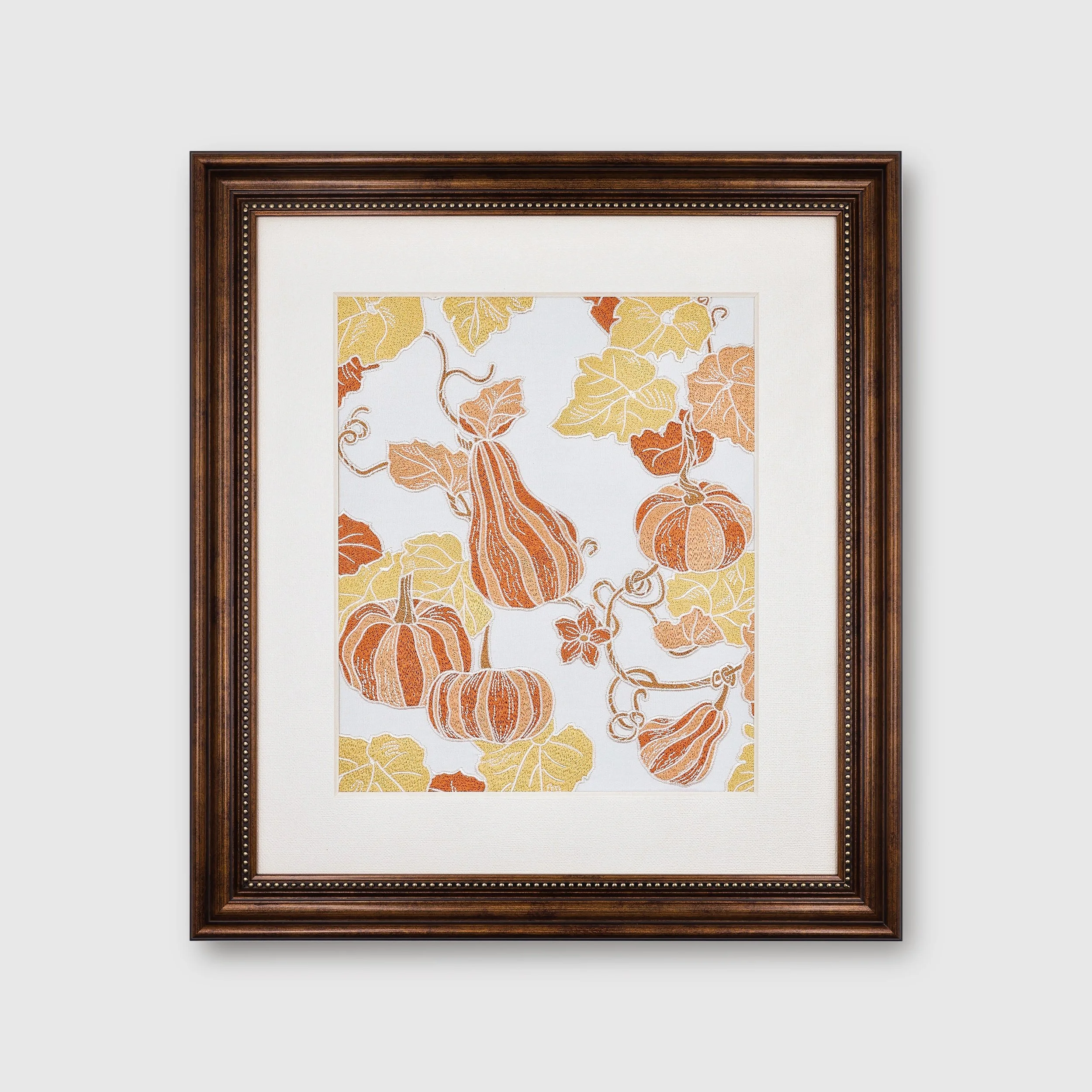 Front view of pumpkin embroidered wall art in brown frame — Pam Pan Pumpkin Series, autumn home decoration artwork with orange and golden stitching.
