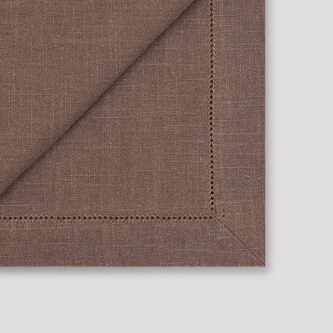 Dark brown hemstitched napkin backside and mitered cornerdetails