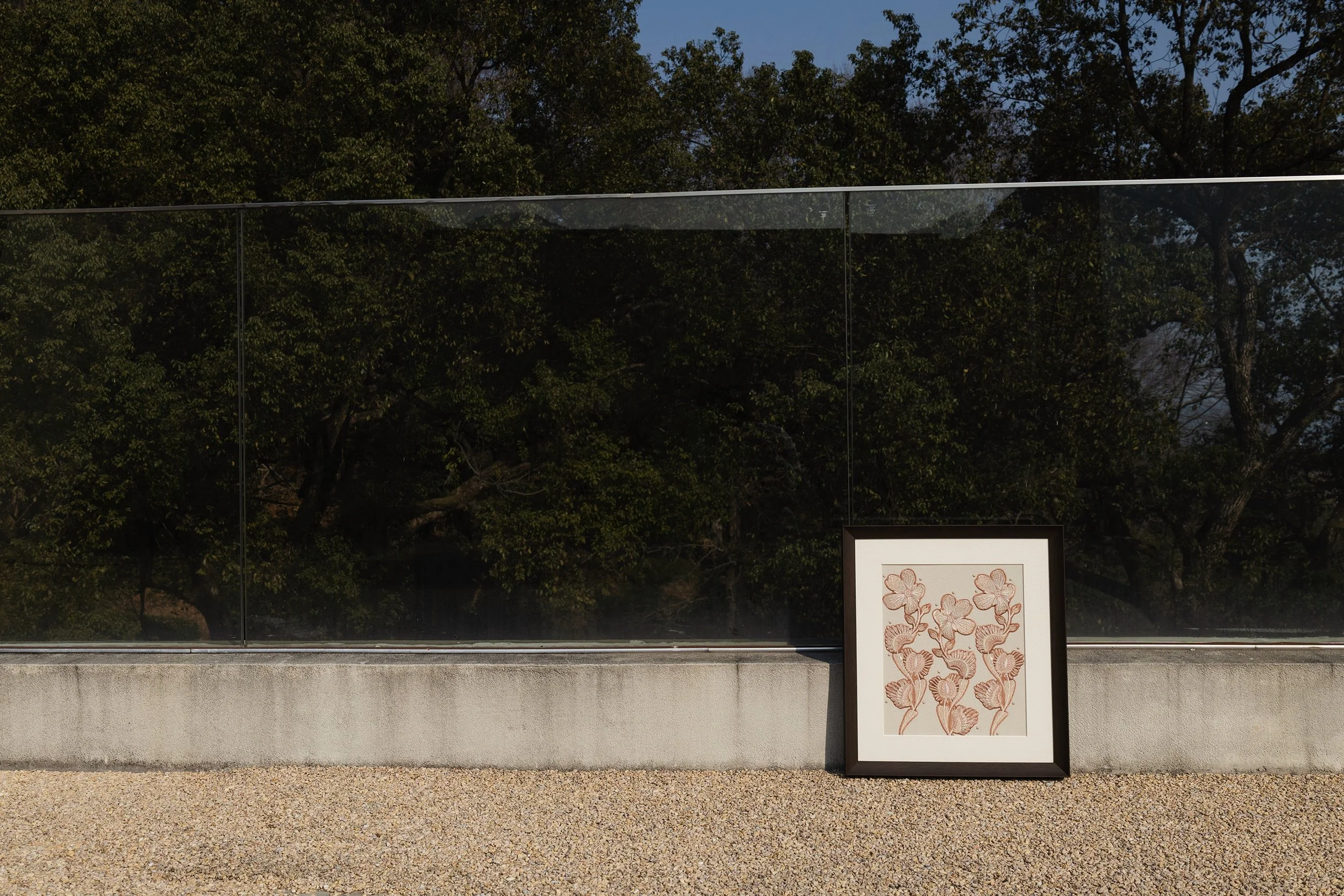 venus flytrap embroidery wall art framed and placed outdoors with botanical textile artwork in natural setting