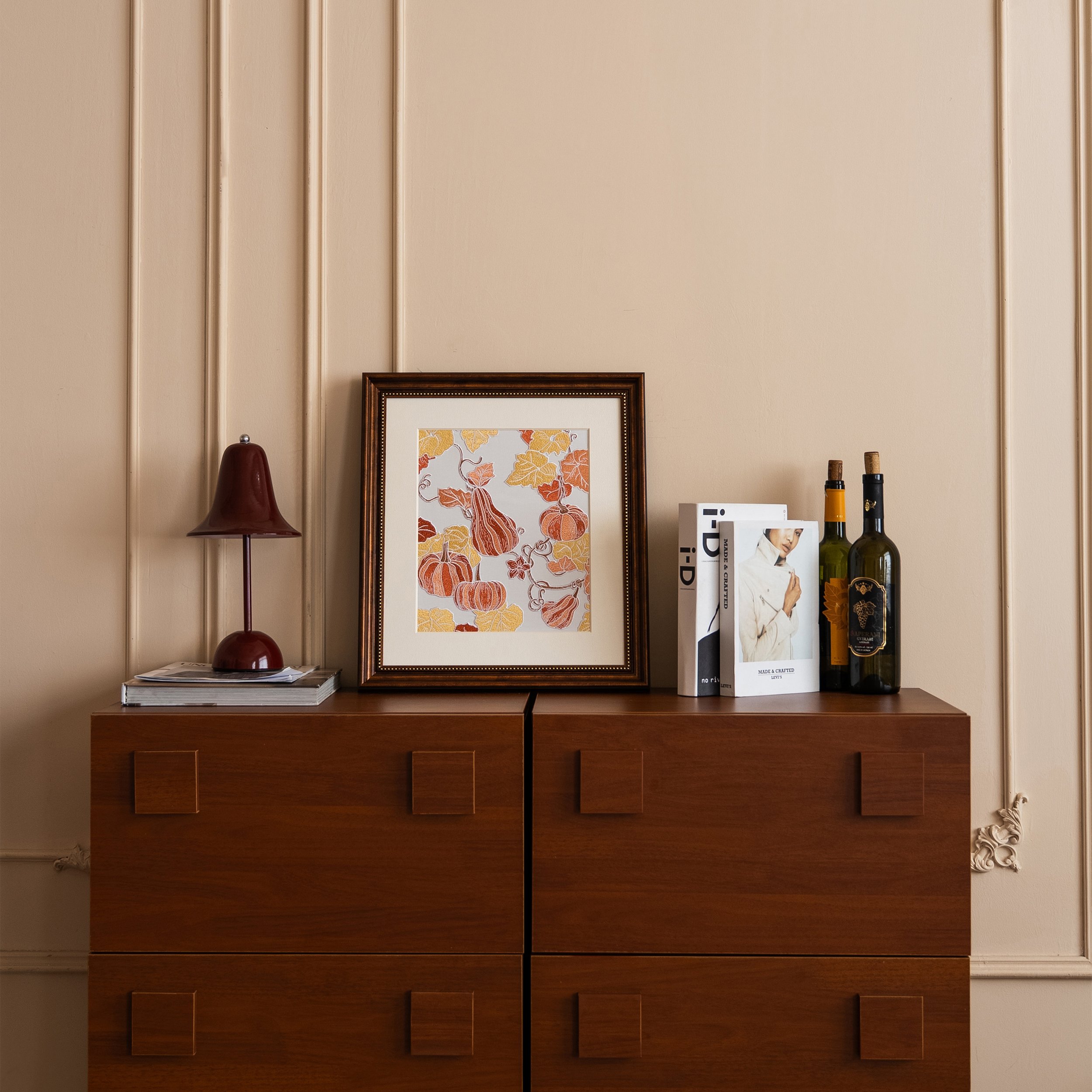 Pumpkin embroidered wall art displayed on wooden cabinet — cozy fall home styling and seasonal decoration by Pam Pan.