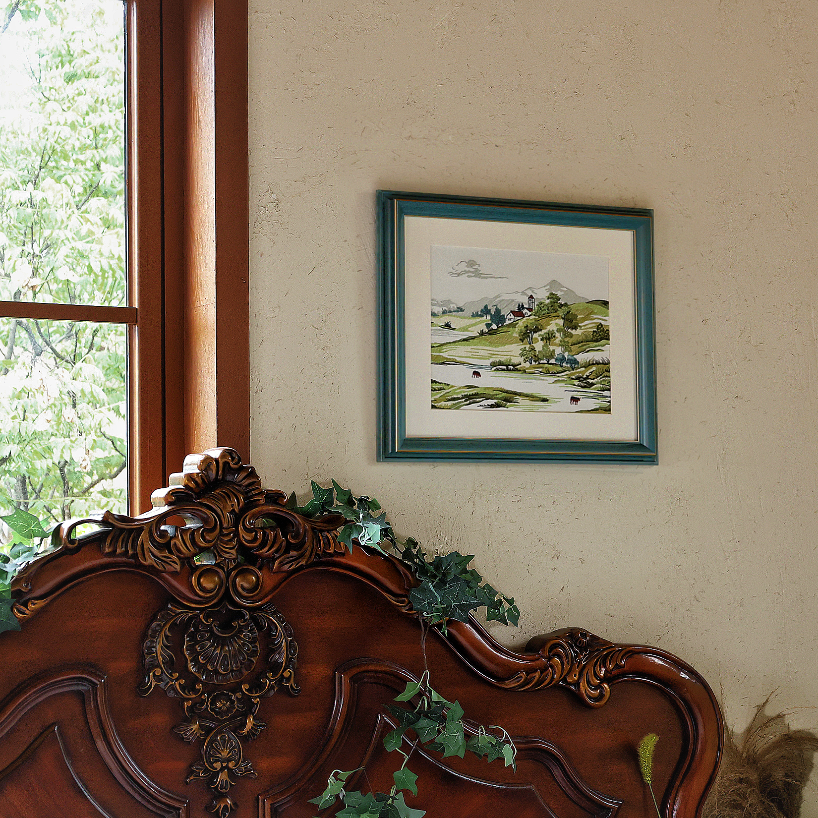 Spring landscape embroidered art hanging on a bedroom wall