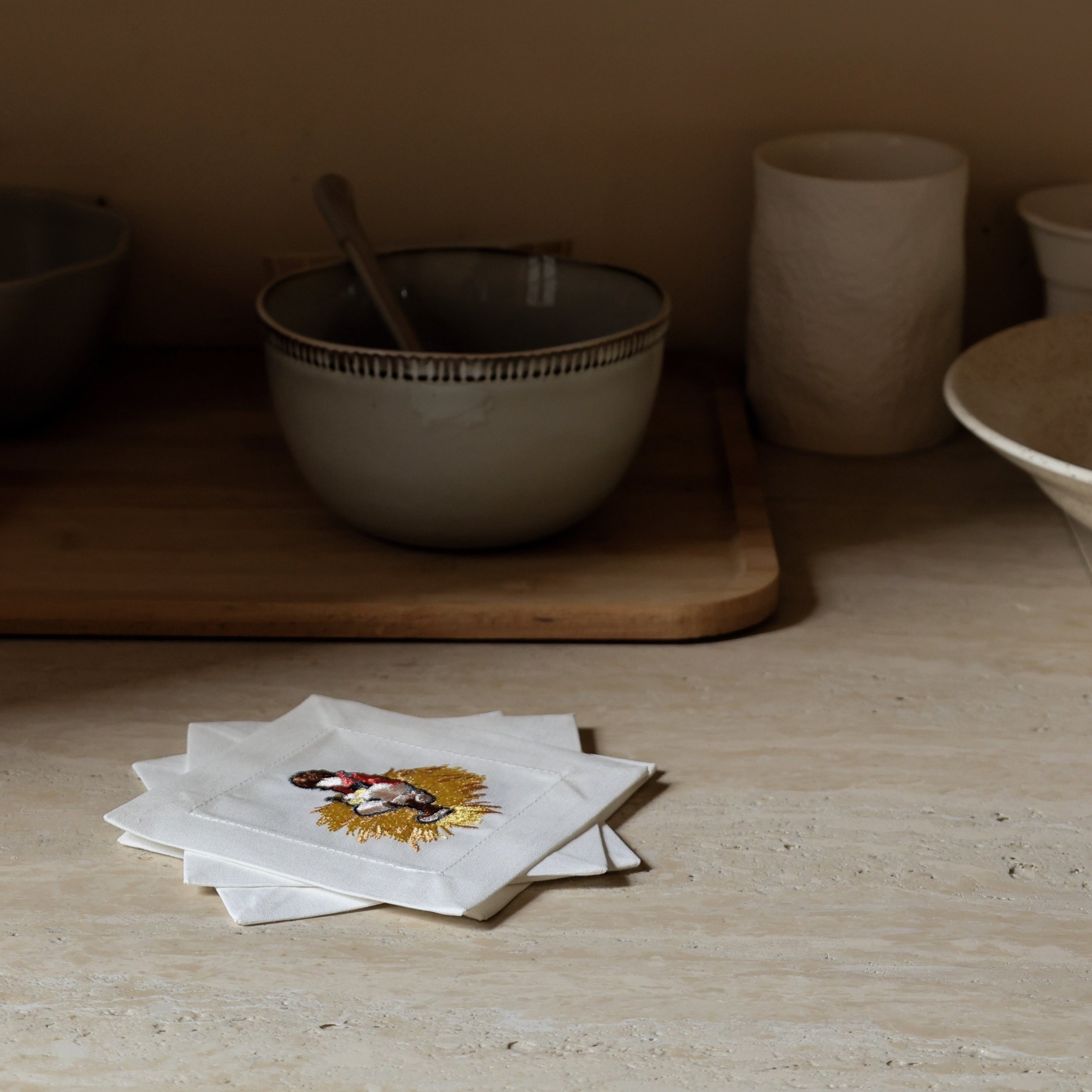 “Wild Corner” Embroidered Cocktail Napkin Set on Kitchen Counter