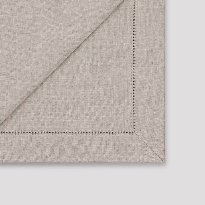 Mitered corner details of grey ramie hemstitched napkin