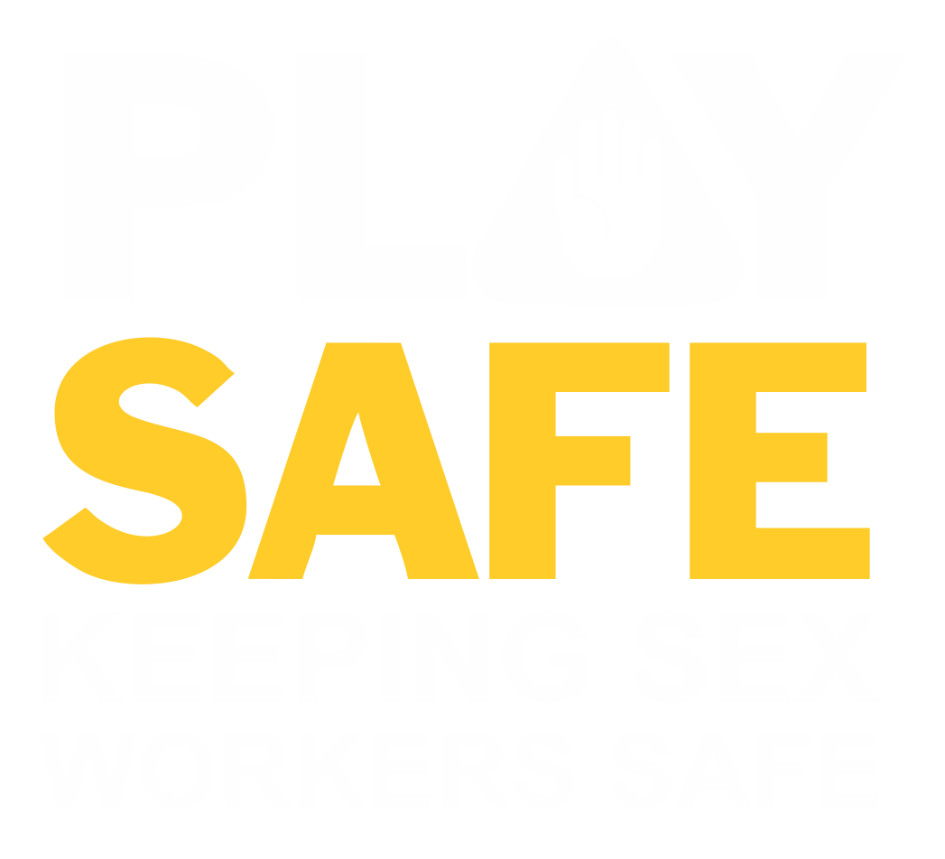 A sign with the message 'Play Safe, Keeping Sex Workers Safe' in bold white and yellow letters on a black background, with a hand symbol within an 'O' in the word 'Play.'