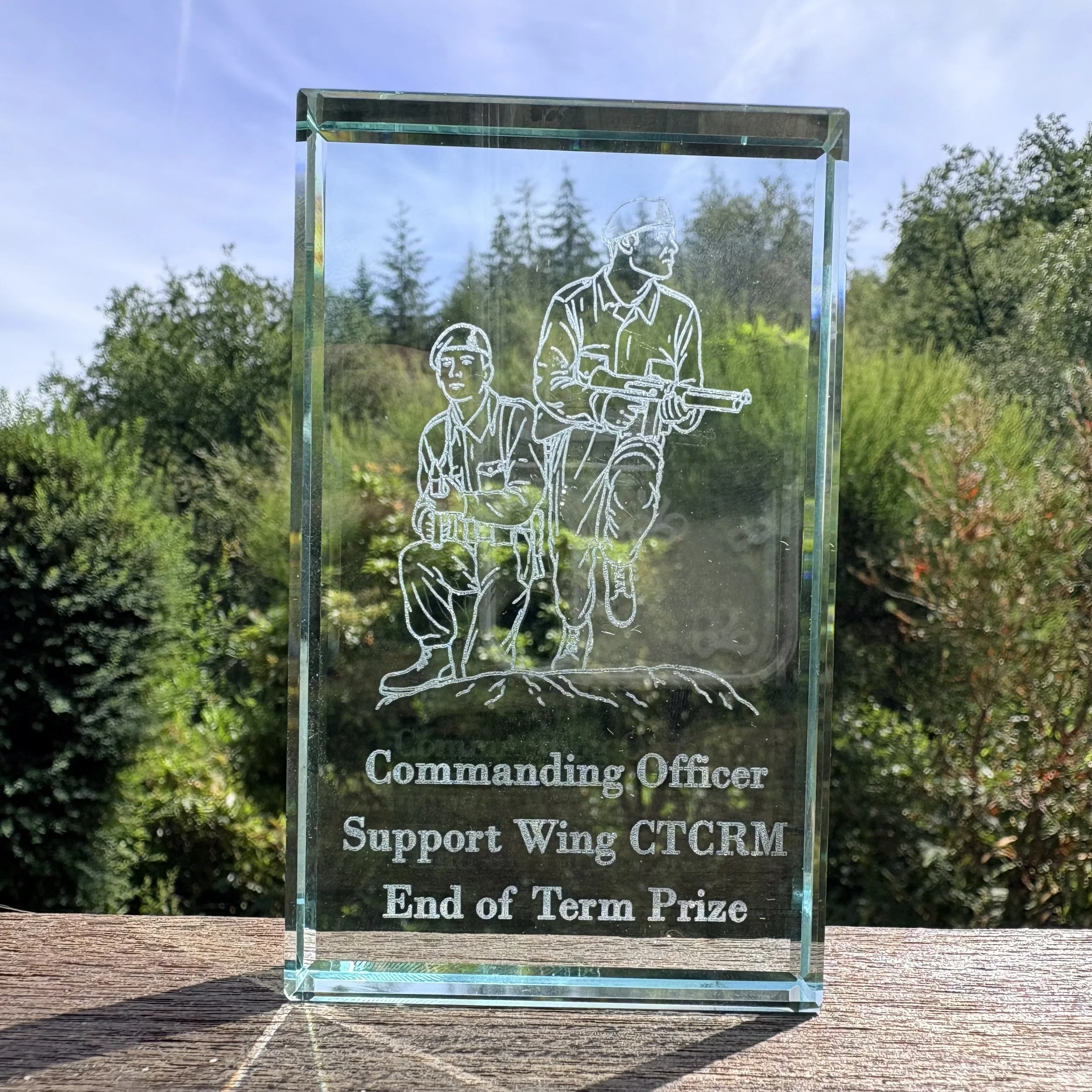 Close-up of laser-engraved glass block paperweight with Royal Marines Commando training engraving