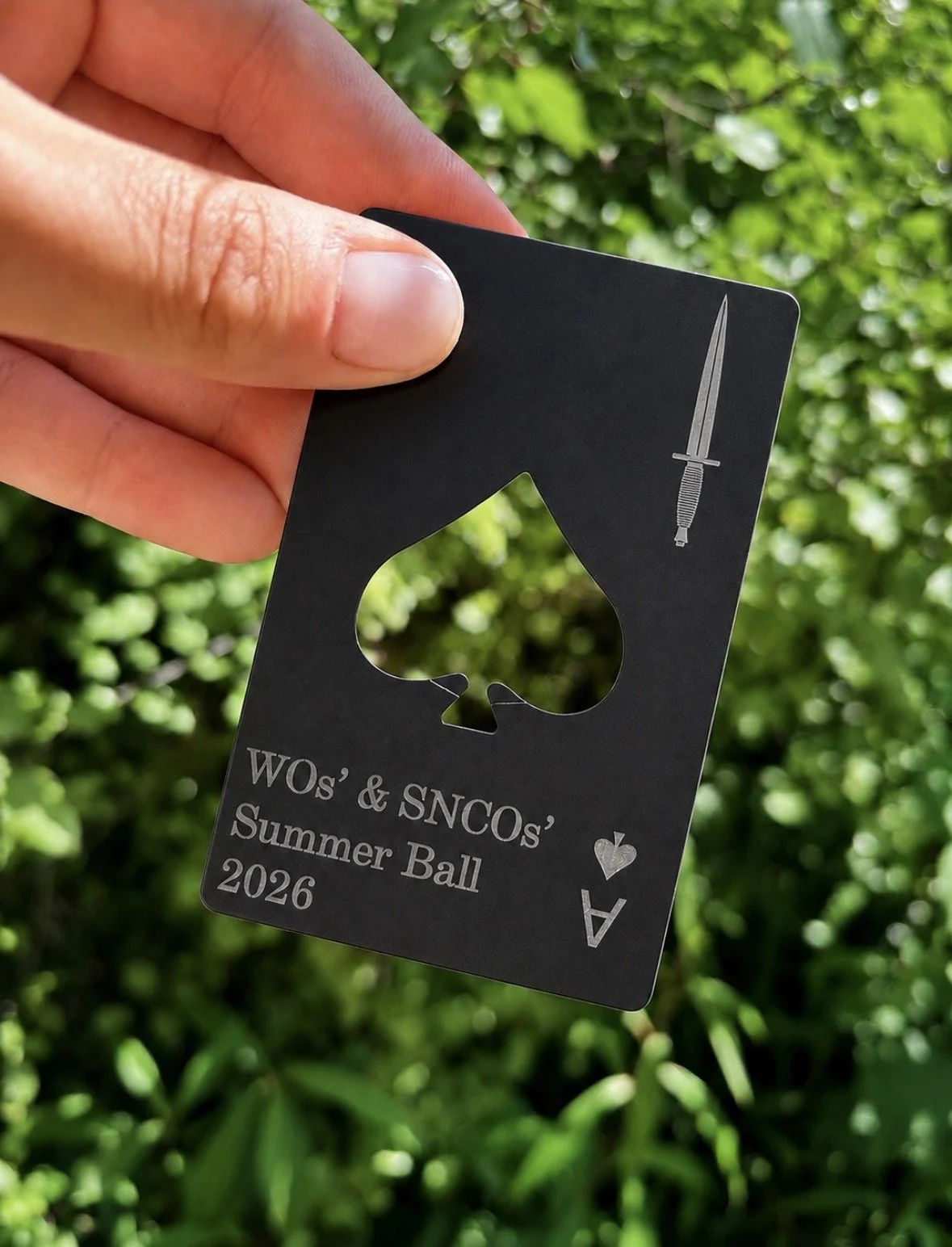 Black matte metal Ace of Spades playing card bottle opener engraved with commando dagger and personalised event text