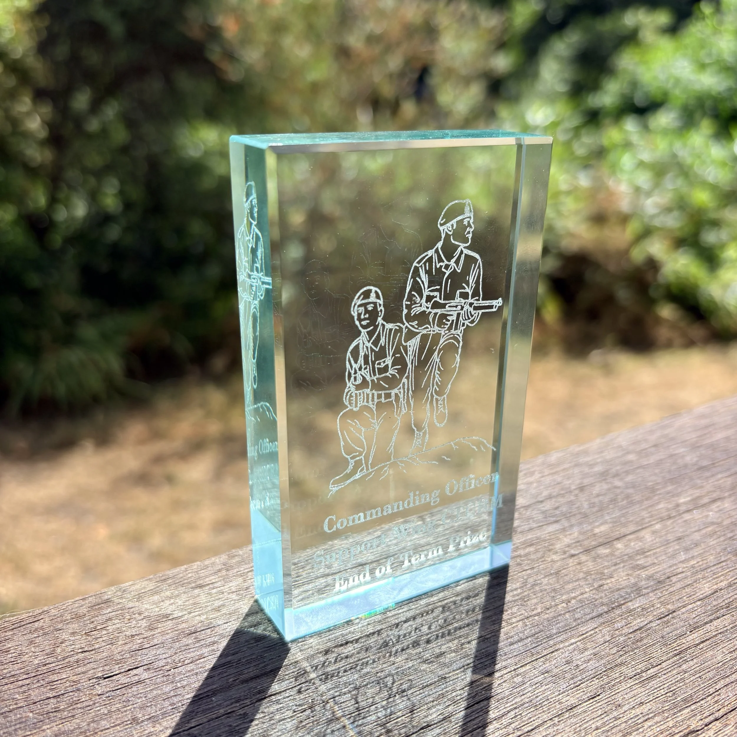Close-up of laser-engraved glass block paperweight with Royal Marines Commando training engraving