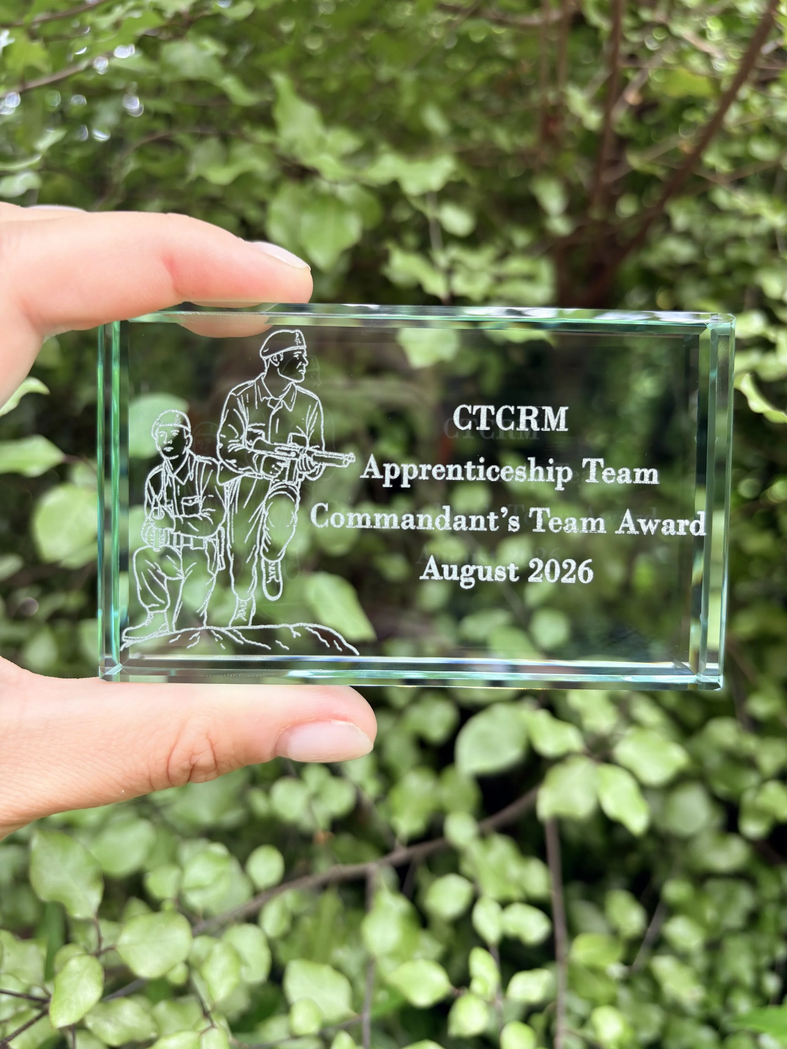 Close-up of laser-engraved glass block paperweight with Royal Marines Commando training engraving
