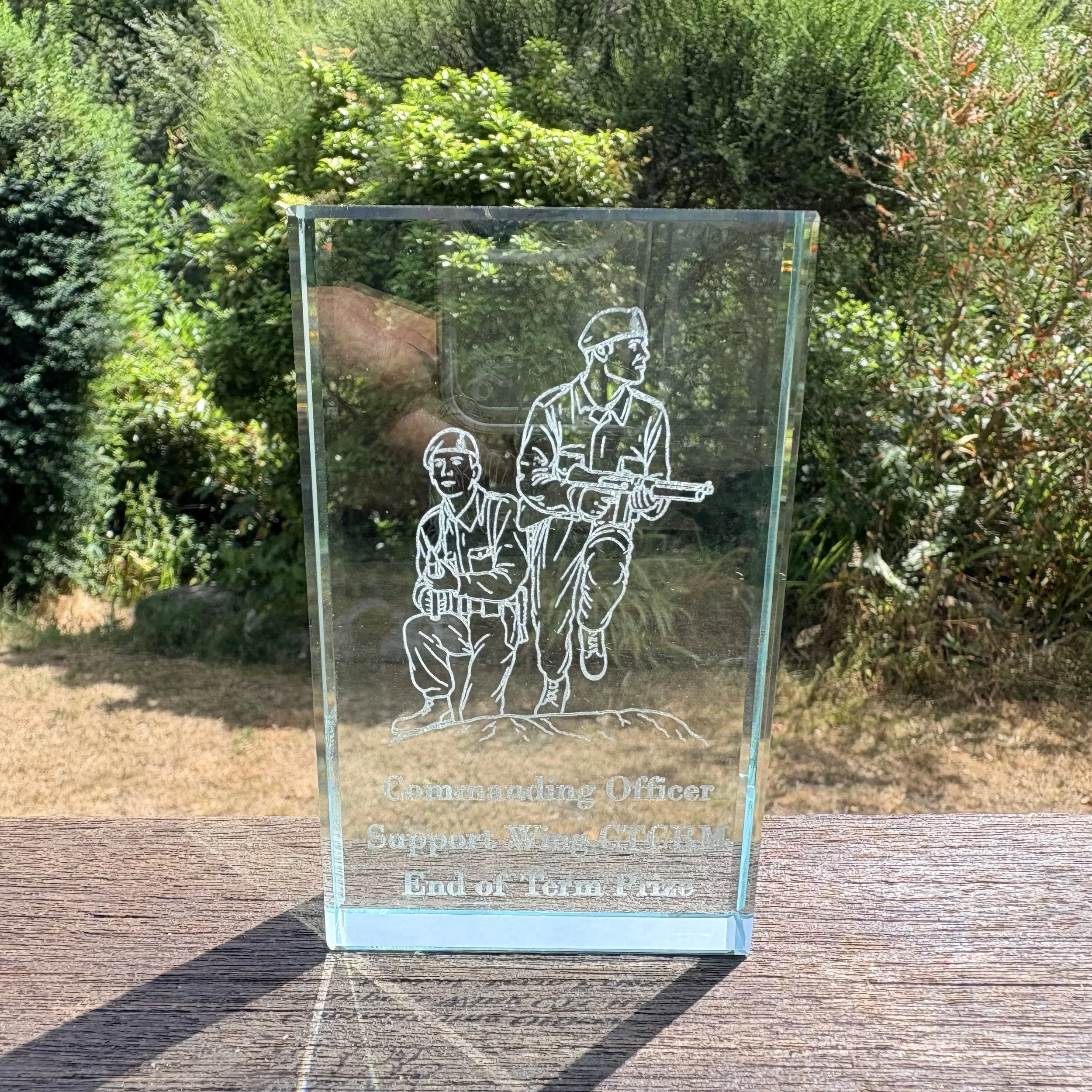 Close-up of laser-engraved glass block paperweight with Royal Marines Commando training engraving