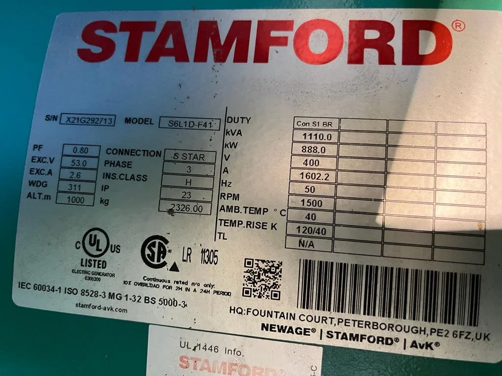 Label on Stamford electrical generator showing specifications and certifications, including model S6L1D-F41, serial number X21G292713, kVA 1110, and a voltage of 400V. Includes certification logos and contact information for Newage Stamford.