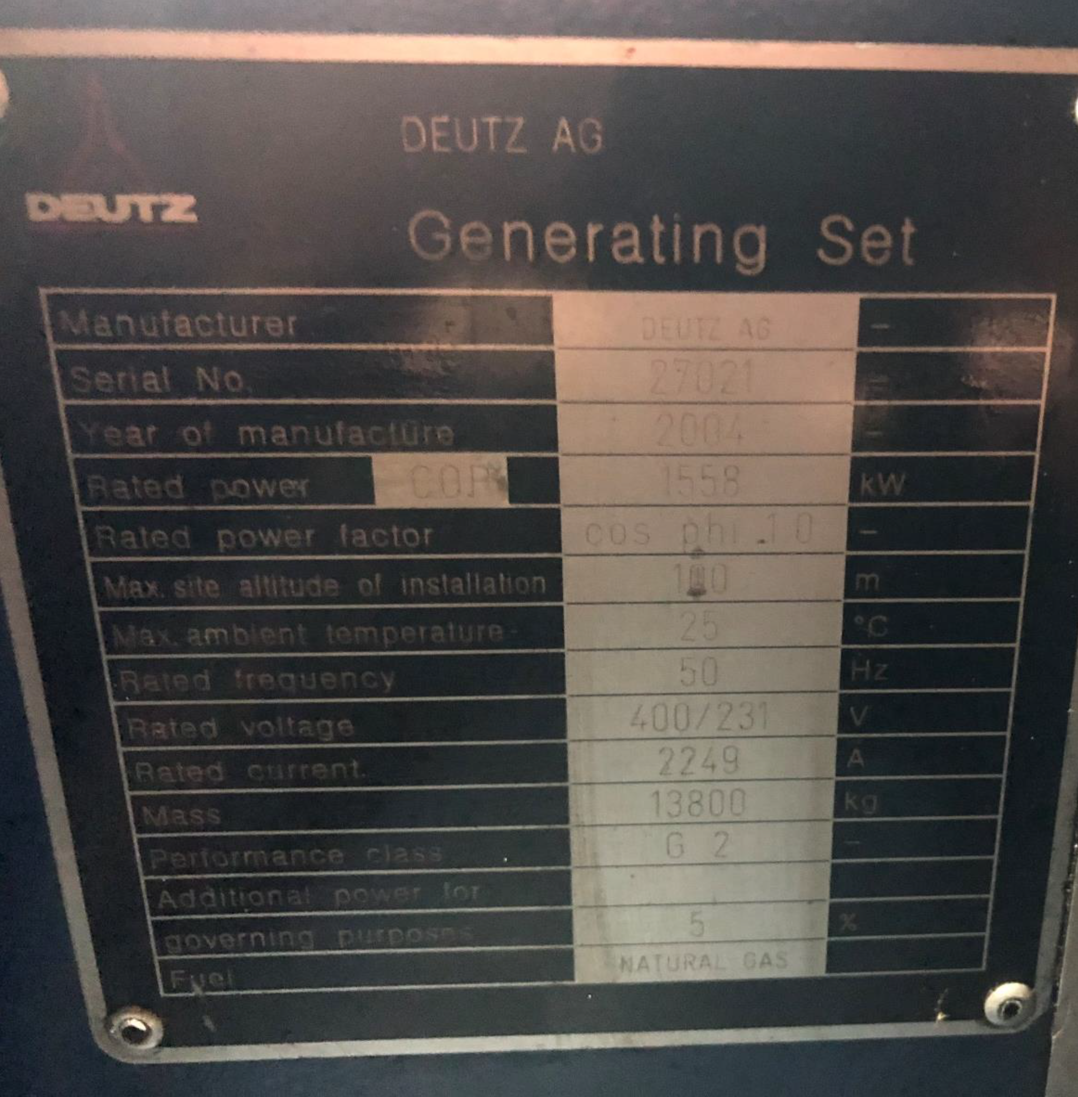 Close-up of a nameplate on a Deutz AG Generating Set, showing specifications such as manufacturer, serial number, year of manufacture (2004), rated power (1558 kW), voltage (400/231 V), and fuel type (natural gas).