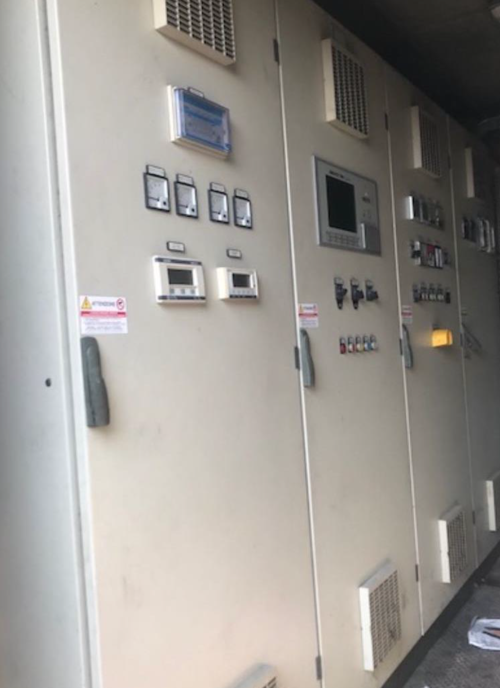 Industrial control panel with switches and meters.