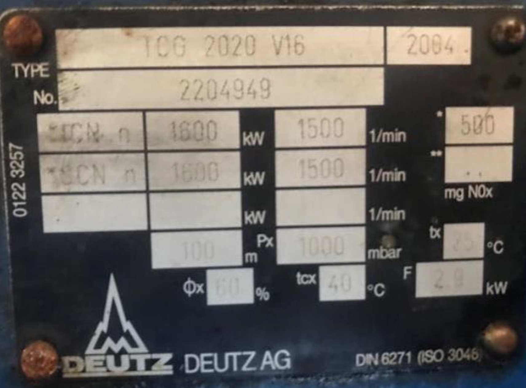 The image displays a metal nameplate of a Deutz AG engine model TCG 2020 V16 from 2004, showing specifications such as type number, power output in kilowatts, emission rates, and operational data.