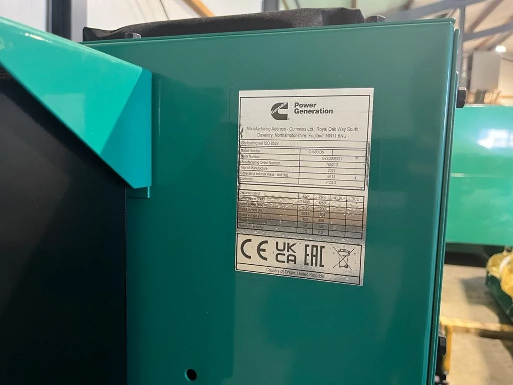 Close-up of a Cummins Power Generation label on equipment, detailing manufacturing address, model number, and compliance logos.