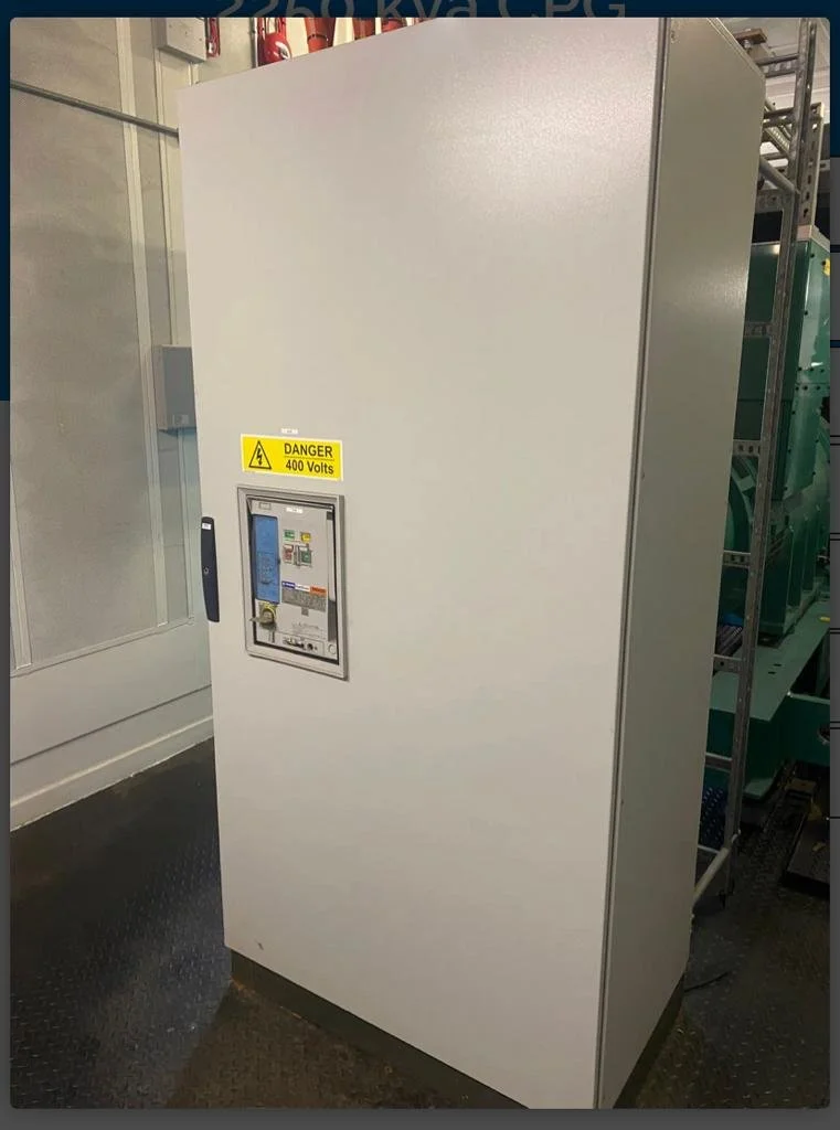 Industrial electrical cabinet labeled 'Danger 400 Volts' in a machine room.