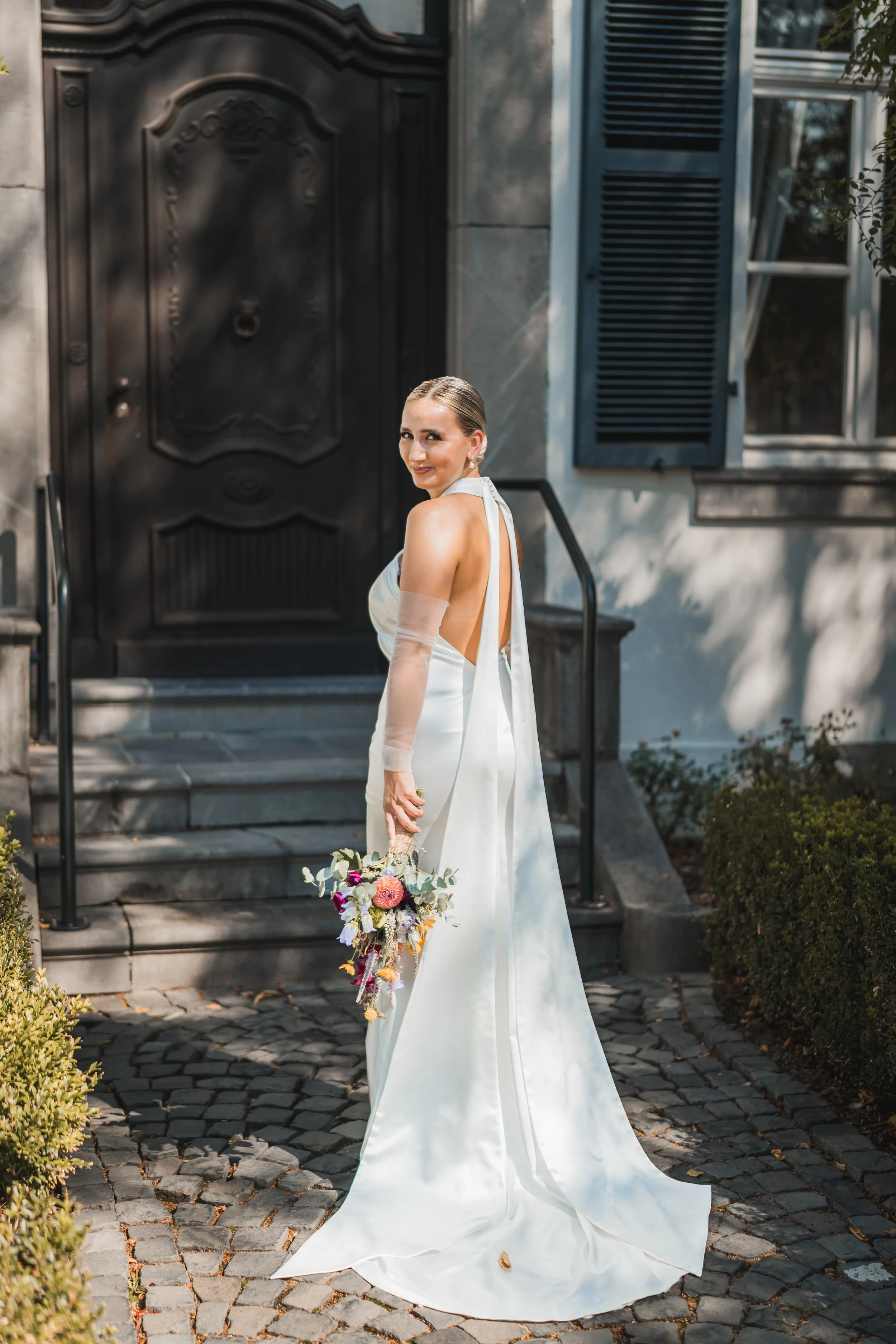 Foto einer Braut an ihrem Hochzeitstag mit ihrem Brautstraß in einem weißen Kleid